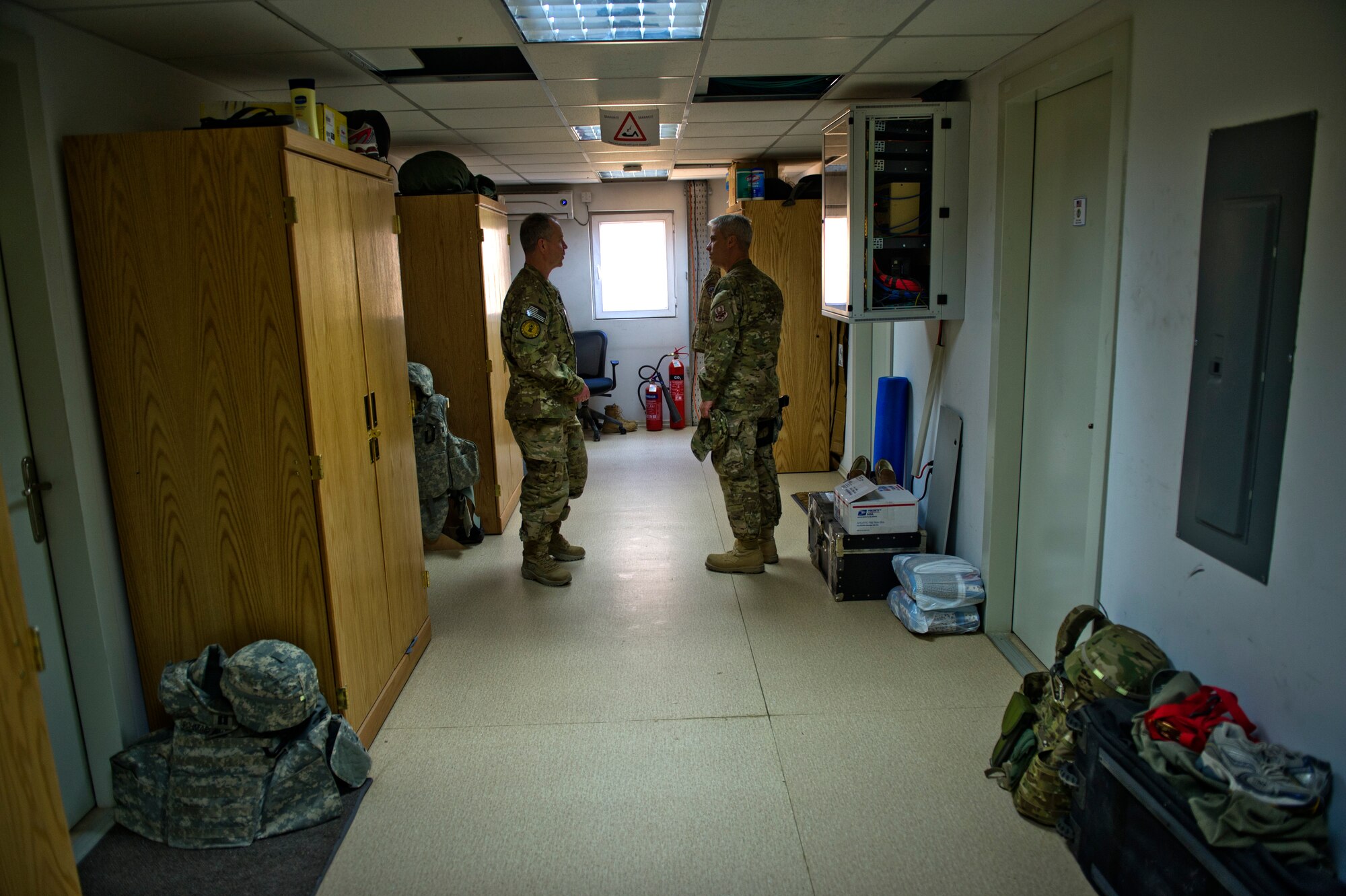 From right, Senior Master Sgt. Jim Essary, 9th Air and Space Expeditionary Task Force - Afghanistan, explains the living arrangements for his unit to Chief Master Sgt. Robert Sealey, U.S. Air Forces Central command chief, March 12, 2012 at Kabul International Airport, Afghanistan. (U.S. Air Force photo by Staff Sgt David Salanitri)