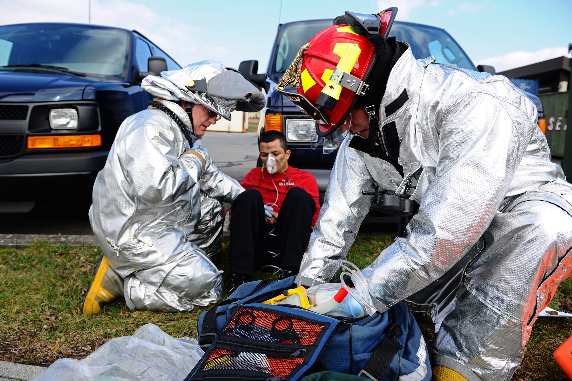 SPANGDAHLEM AIR BASE, Germany – Firefighters from the 52nd Civil Engineer Squadron administer first aid to explosion Airman 1st Class John Soto, 52nd Equipment Maintenance Squadron, a simulated victim of a car bomb during a barrier plan exercise here March 19. Airmen from the 52nd Logistics Readiness Squadron placed barriers to test the base’s ability to respond to an increased defensive posture. The exercise included a mock car bomb explosion to test the wing’s response to an emergency situation. This type of training prepares first responders to protect the base and U.S. government assets and tests base members’ responses to real-world emergency events. (U.S. Air Force photo by Airman 1st Class Matthew B. Fredericks/Released)