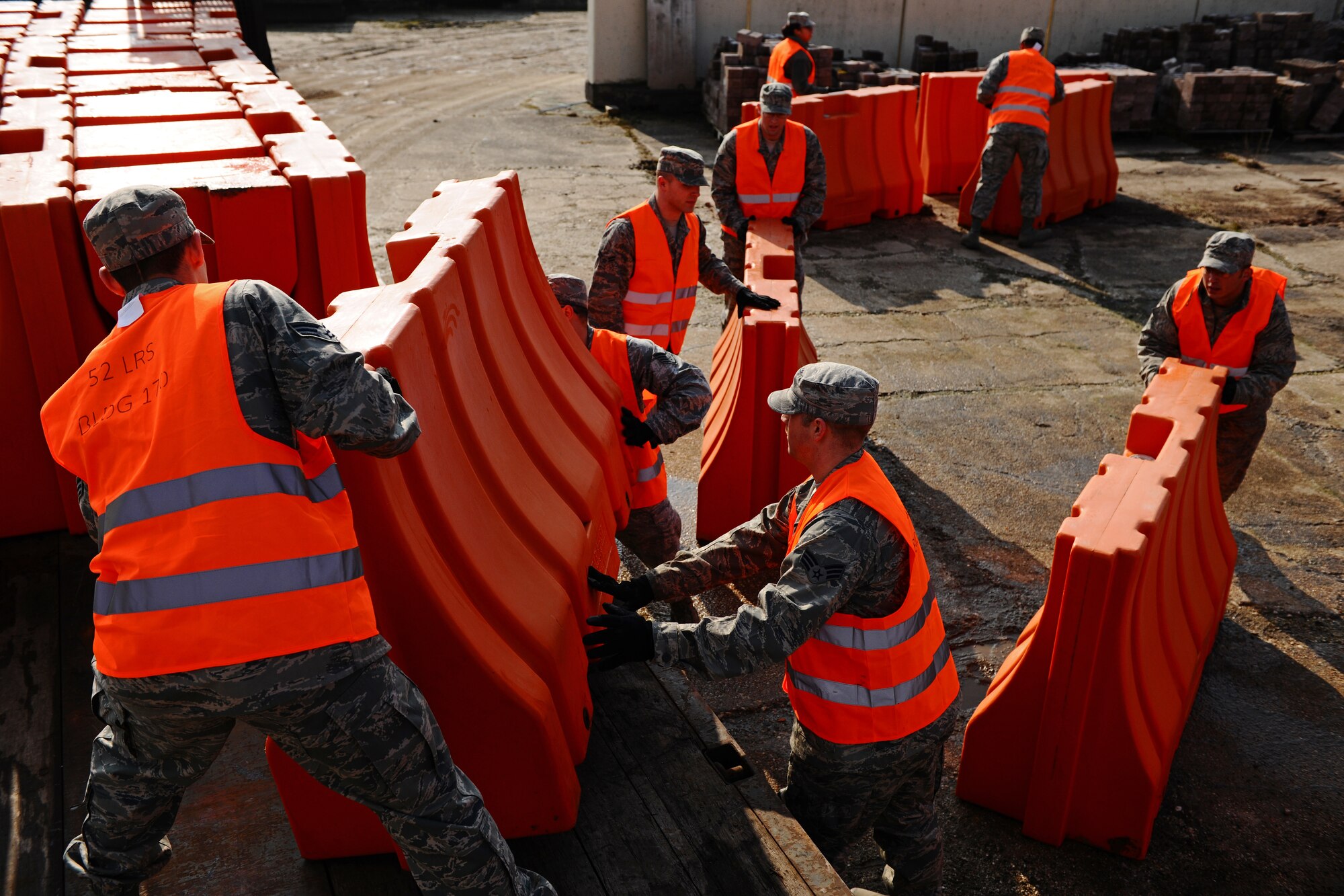 SPANGDAHLEM AIR BASE, Germany – Airmen from the 52nd Logistics Readiness Squadron load barriers onto a transport vehicle during a barrier plan exercise here March 19. LRS Airmen placed barriers to test the base’s ability to respond to an increased defensive posture. The exercise also included a mock car bomb explosion to test the wing’s response to an emergency situation. This type of training prepares first responders to protect the base and U.S. government assets and tests base members’ responses to real-world emergency events. (U.S. Air Force photo by Airman 1st Class Matthew B. Fredericks/Released)