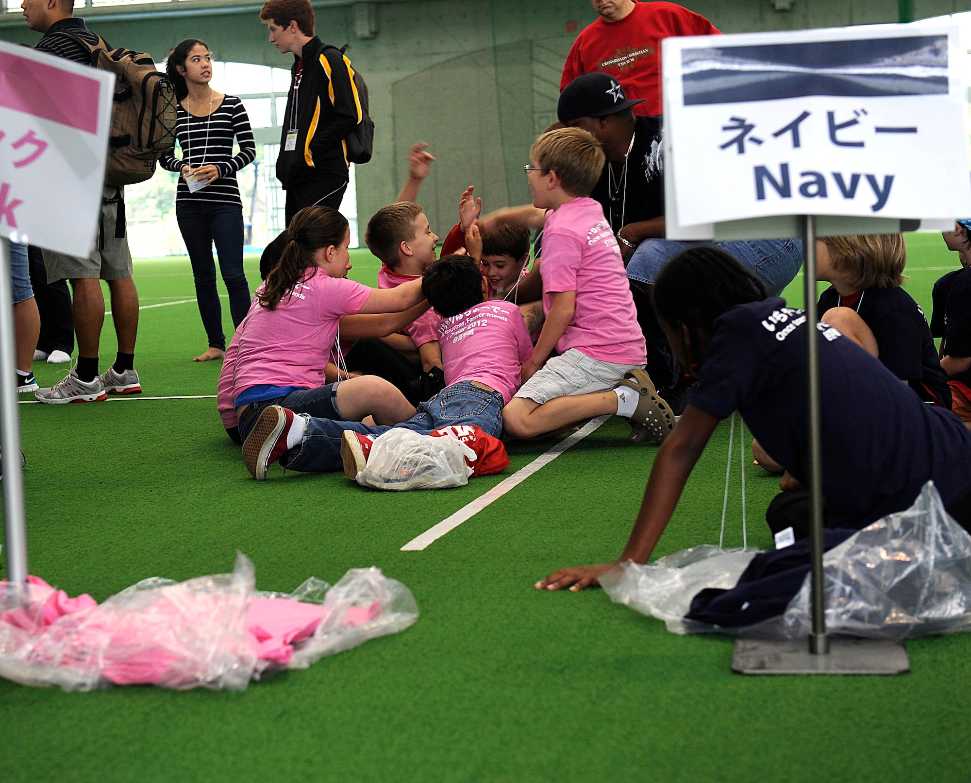 American and Japanese students are broken into different teams while participating in a Japan-U.S. Friendship Day sports event March 17, 2012, in Kadena Town, Japan. The American students were from Amelia Earhart Intermediate School on Kadena Air Base and the Japanese students were from Kadena Town. (U.S. Air Force photo by Senior Master Sgt. J.C. Woodring/Released)