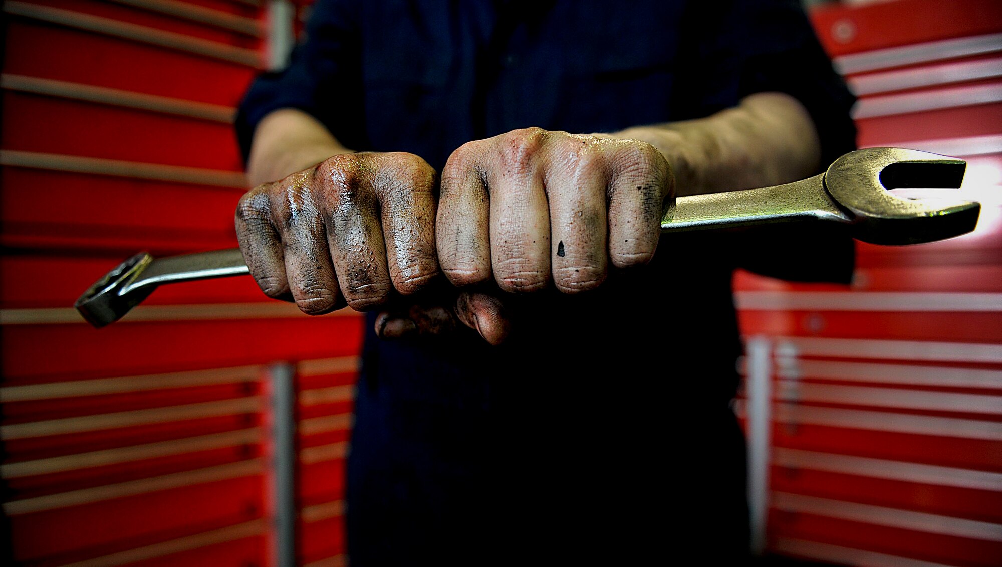U.S. Air Force Senior Airman Craig Galvin, 18th Logistics Readiness Squadron vehicle maintenance journeyman, shows off his hands covered in grime after working on a truck on Kadena Air Base, Japan, March 21, 2012. Galvin and the other members of vehicle maintenance help keep Shogun Airmen mobile so the Kadena mission can be completed more efficiently. (U.S. Air Force photo by Airman 1st Class Brooke P. Beers/Released)