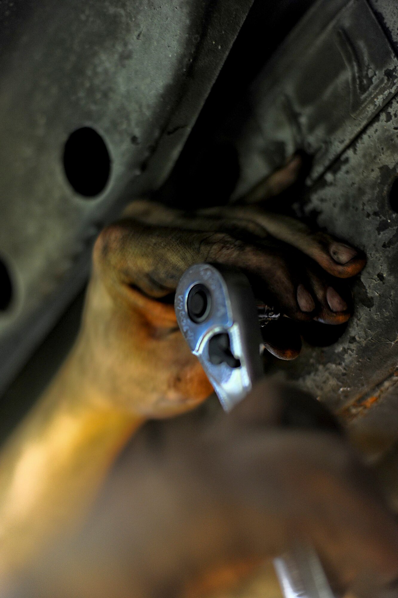 U.S. Air Force Senior Airman Craig Galvin, 18th Logistics Readiness Squadron vehicle maintenance journeyman, loosens a bolt while replacing a flex plate in a truck on Kadena Air Base, Japan, March 20, 2012. Although Galvin has only been a mechanic in the Air Force for two years, he has been fixing vehicles since he was 16 years old. (U.S. Air Force photo by Airman 1st Class Brooke P. Beers/Released)
