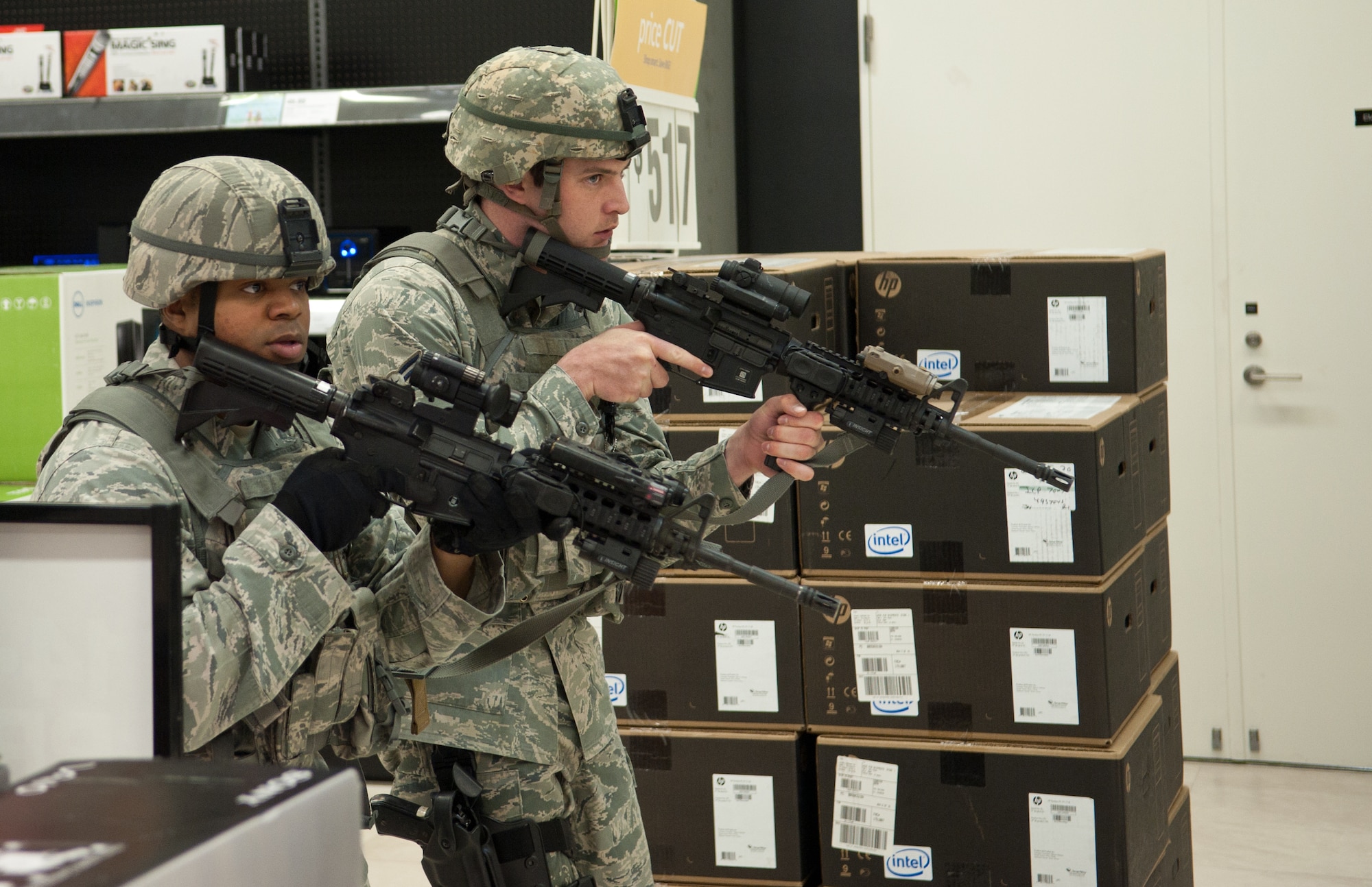 YOKOTA AIR BASE, Japan -- Staff Sgt. Anthony Simmons, (left), and Airman 1st Class Patrick Kelly, 374th Security Forces Squadron patrolmen, secure an area during an active shooter scenario at Yokota Air Base, Japan, March 16, 2012. Several locations were used At Yokota Air Base, Japan, March 15 and 16 for the training scenarios, testing how teams reacted to a range of different terrains and building layouts. (U.S. Air Force photo/Airman 1st Class John D. Partlow)