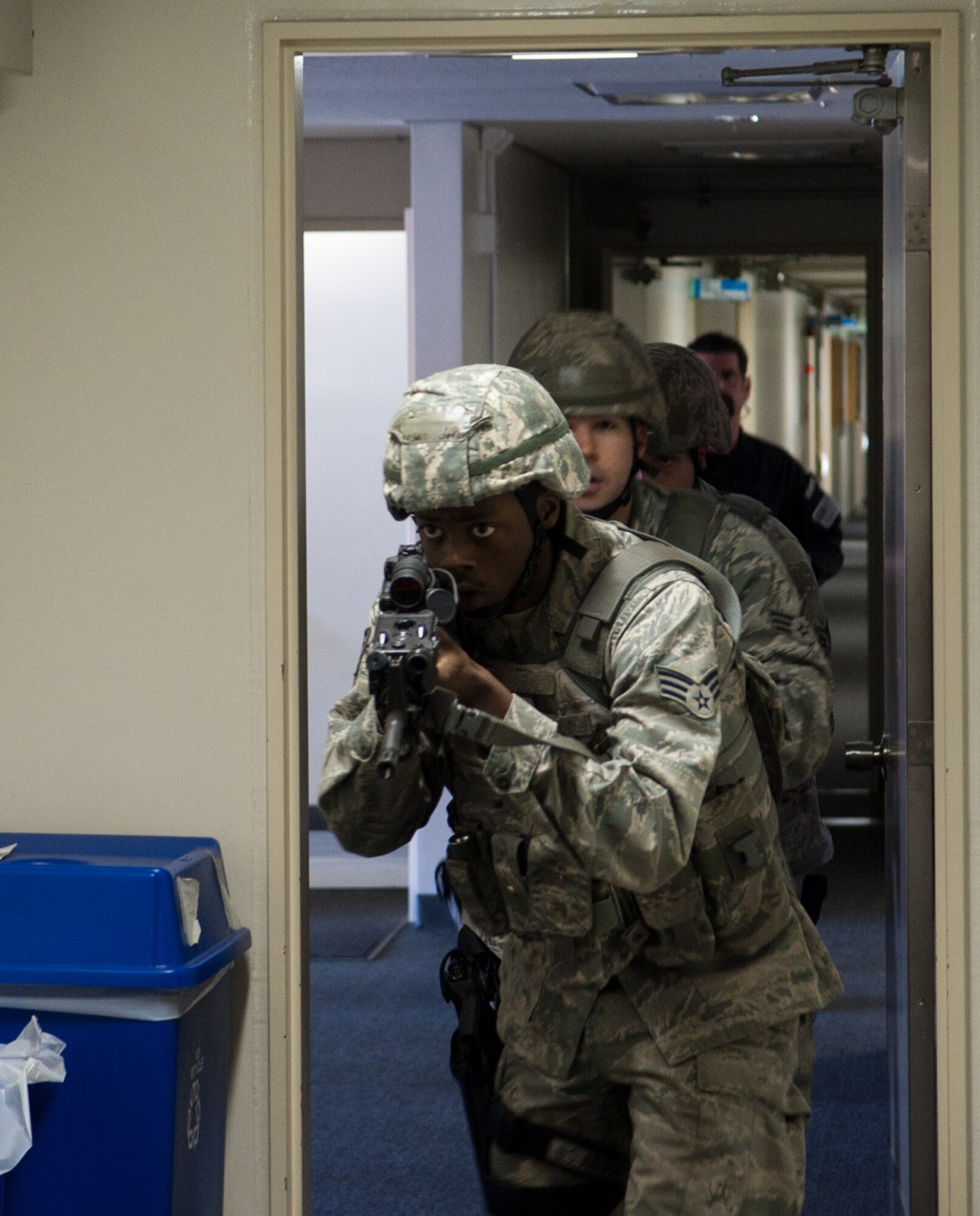 YOKOTA AIR BASE, Japan -- Senior Airman Jermaine Anderson, 374th Security Forces Squadron patrolman, leads a team of security forces members down a hallway during an active shooter scenario at Yokota Air Base, Japan, March 15, 2012. Security Forces teams used the Exchange, Commissary and several other locations around the base to conduct the training. (U.S. Air Force photo/Airman 1st Class John D. Partlow)