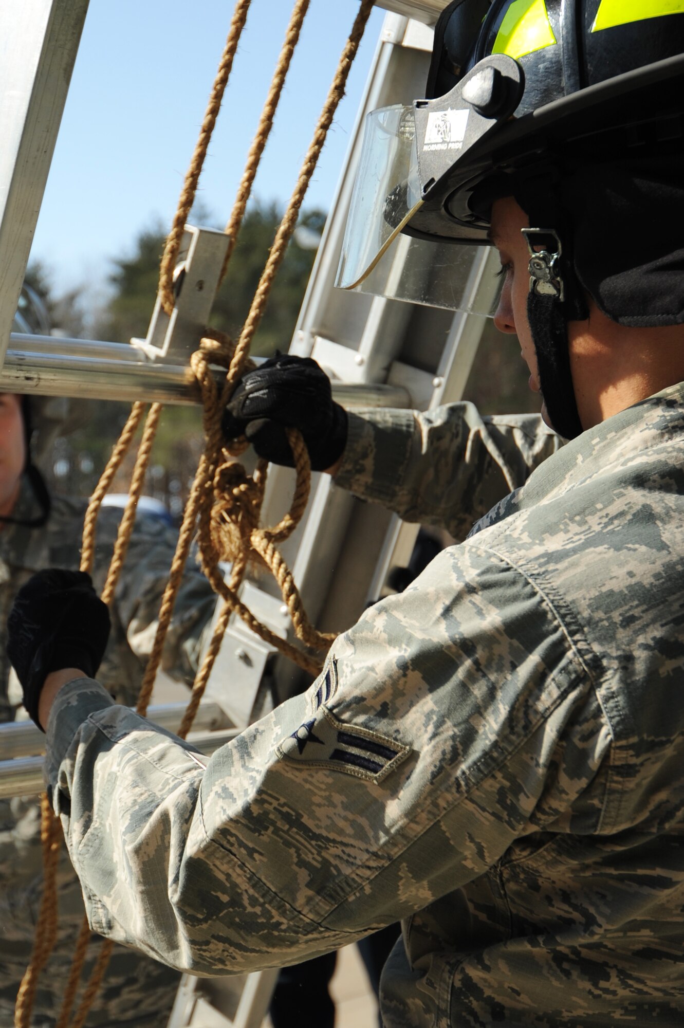 U.S. Air Force Airman 1st Class Tyler England, 35th Civil Engineer Squadron fireman, secures a ladder with a clove hitch knot at Misawa Air Base, Japan, March 1, 2012. There are more than a dozen knots that firemen must memorize. (U.S. Air Force photo by Kia Atkins/Released)