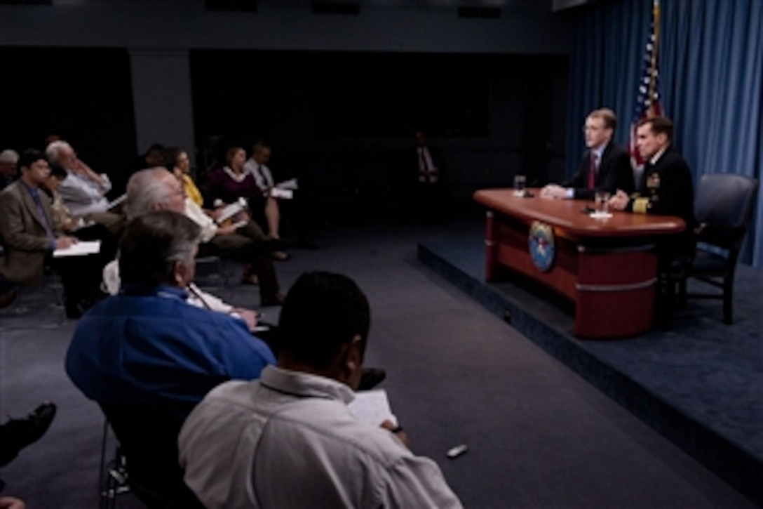 Pentagon Press Secretary George Little and Capt. John Kirby, U.S. Navy, brief the Pentagon press corps on March 21, 2012.  