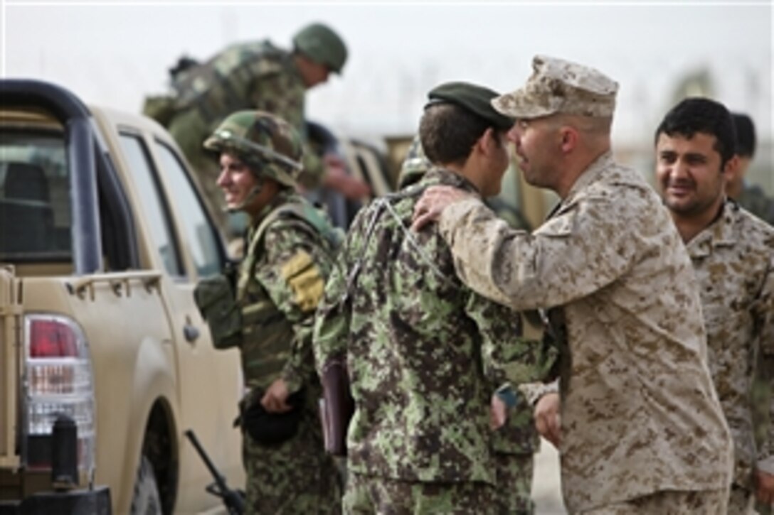 U.S. Marine Corps Lt. Col. Luke Kratky shakes the hand of an Afghan soldier before the Regional Logistics Support Company Southwest advisor team performs its first independent, cross-boundary combat logistics patrol on Camp Shorabak, Afghanistan, March 15, 2012. Kratky is the team's officer in charge.