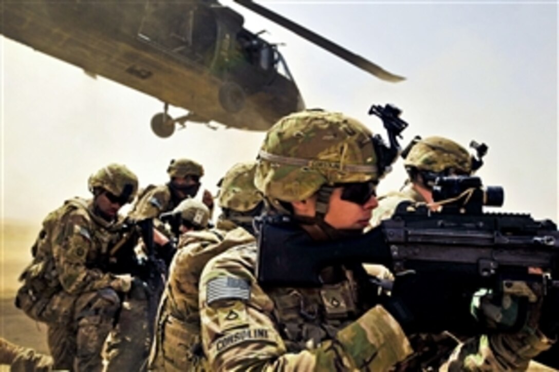 U.S. Army Pfc. Samuel Corsolini uses his weapon's scope to provide security as a UH-60 Black Hawk helicopter takes off after unloading U.S. and Afghan troops during a vehicle interdiction to disrupt Taliban activities as part of Operation Pranoo Verbena in Kandahar province, Afghanistan, March 16, 2012. Corsolini is a gunner assigned to the Company F, 2nd Battalion, 25th Aviation Regiment, 25th Combat Aviation Brigade.