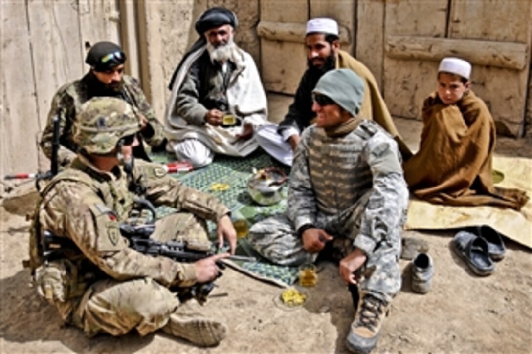 U.S. Army 2nd Lt. Jeffery Russell (left) sits with his interpreter, Zorro, an Afghan soldier, and residents during an event with leaders in the village of Sader Kheyl, Afghanistan, on March 17, 2012.  Russell is a platoon leader assigned to Company B, 3rd Battalion, 509th Infantry Regiment.  
