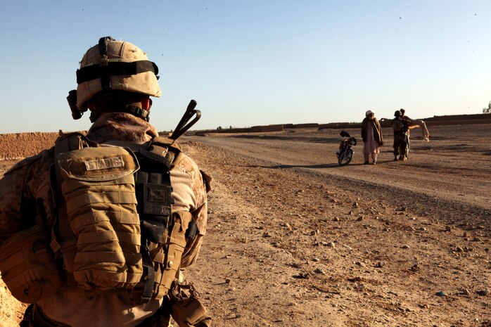 U.S. Marine Cpl. Glenn Stadig, a squad leader with Weapons Company, 2nd Battalion, 9th Marine Regiment, provides security for Afghan National Army soldiers with 3rd Kandak, 1st Brigade, 215th Corps, at a vehicle checkpoint here, March 22, 2012. In addition to advising Afghan forces in the blocks of Marjah, 2nd Bn., 9th Marines conducted partnered counternarcotics missions with the Afghan National Interdiction Unit in the Bari Desert during Operation Psarlay Taba. The partnered force captured around 26,000 pounds of assorted opium products over the course of the four-month operation.