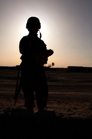 An Afghan National Army soldier with Weapons Tolai, 3rd Kandak, 1st Brigade, 215th Corps, stands his post at a vehicle checkpoint here, March 22, 2012. In addition to advising Afghan forces in the blocks of Marjah, Marines 2nd Battalion, 9th Marine Regiment conducted partnered counternarcotics missions with the Afghan National Interdiction Unit in the Bari Desert during Operation Psarlay Taba. The partnered force captured around 26,000 pounds of assorted opium products over the course of the four-month operation.