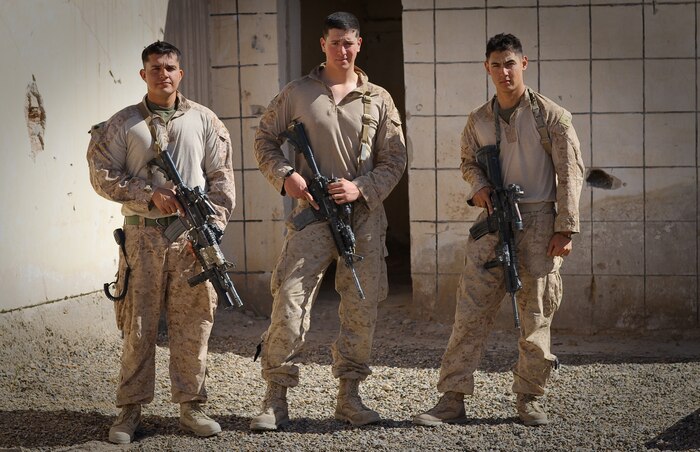 COMBAT OUTPOST CASTLE, Afghanistan – Sergeant Eriek Gutierrez, a squad leader, Lance Cpl. Benjamin Nalls, a light armored vehicle crewman, and Lance Cpl. Christopher D. Bast, a fire team leader, all serving with 1st Platoon, Delta Company, 1st Light Armored Reconnaissance Battalion, pose for a photo here, March 21, 2012. The three Marines were on an evening resupply patrol to another squad of Marines near a small village in Helmand province’s Khan Neshin district, Feb. 23, when they fell in a 15-foot-wide canal at separate times. Each participated in the successful rescue of his fellow Marines, with Nalls jumping back in the near-freezing water when Gutierrez fell in the canal.