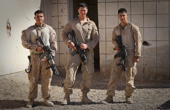 COMBAT OUTPOST CASTLE, Afghanistan – Sergeant Eriek Gutierrez, a squad leader, Lance Cpl. Benjamin Nalls, a light armored vehicle crewman, and Lance Cpl. Christopher D. Bast, a fire team leader, all serving with 1st Platoon, Delta Company, 1st Light Armored Reconnaissance Battalion, pose for a photo here, March 21, 2012. The three Marines were on an evening resupply patrol to another squad of Marines near a small village in Helmand province’s Khan Neshin district, Feb. 23, when they fell in a 15-foot-wide canal at separate times. Each participated in the successful rescue of his fellow Marines, with Nalls jumping back in the near-freezing water when Gutierrez fell in the canal.
