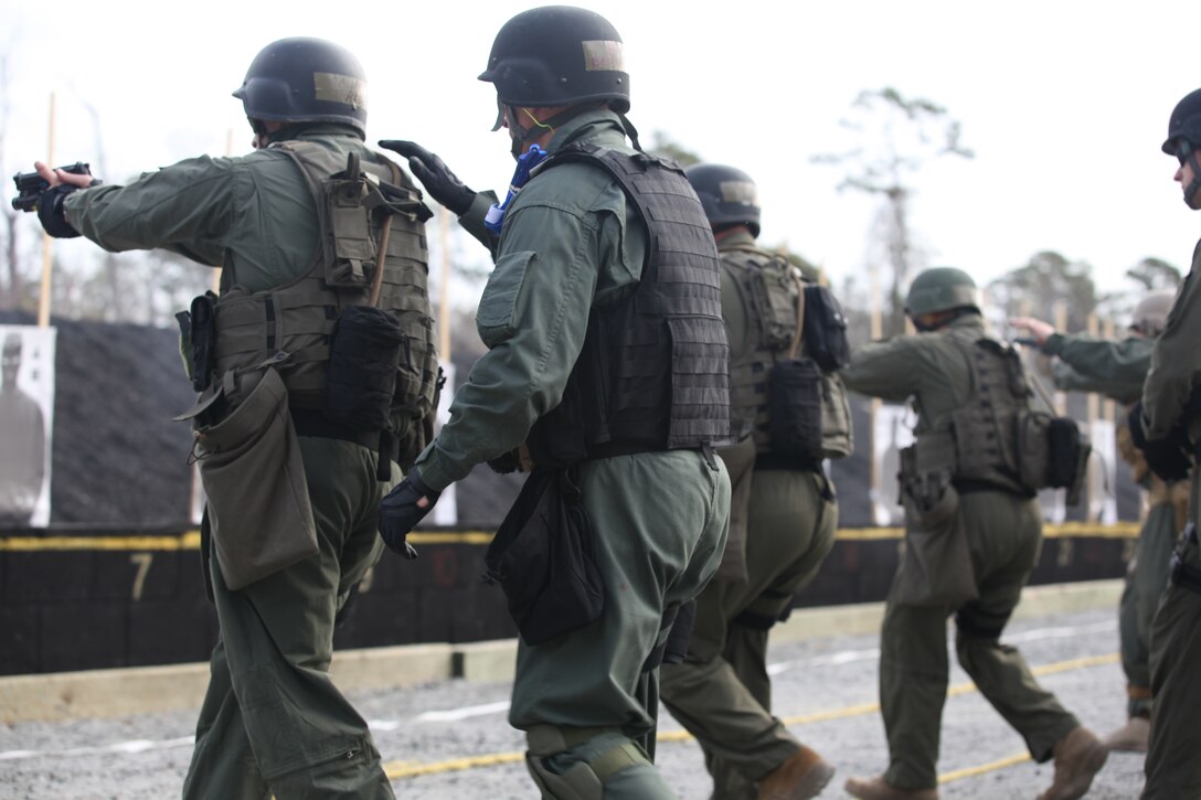 Students of the new Special Reaction Team course train to fire on the move with the aid of their fellow classmates at a Stone Bay range aboard Marine Corps Base Camp Lejeune, March 22. The new course will help Marine Corps installations fill their quota of SRT personnel, who provide a tactical edge to installation commanders looking to plan for and answer possible security and law enforcement threats.