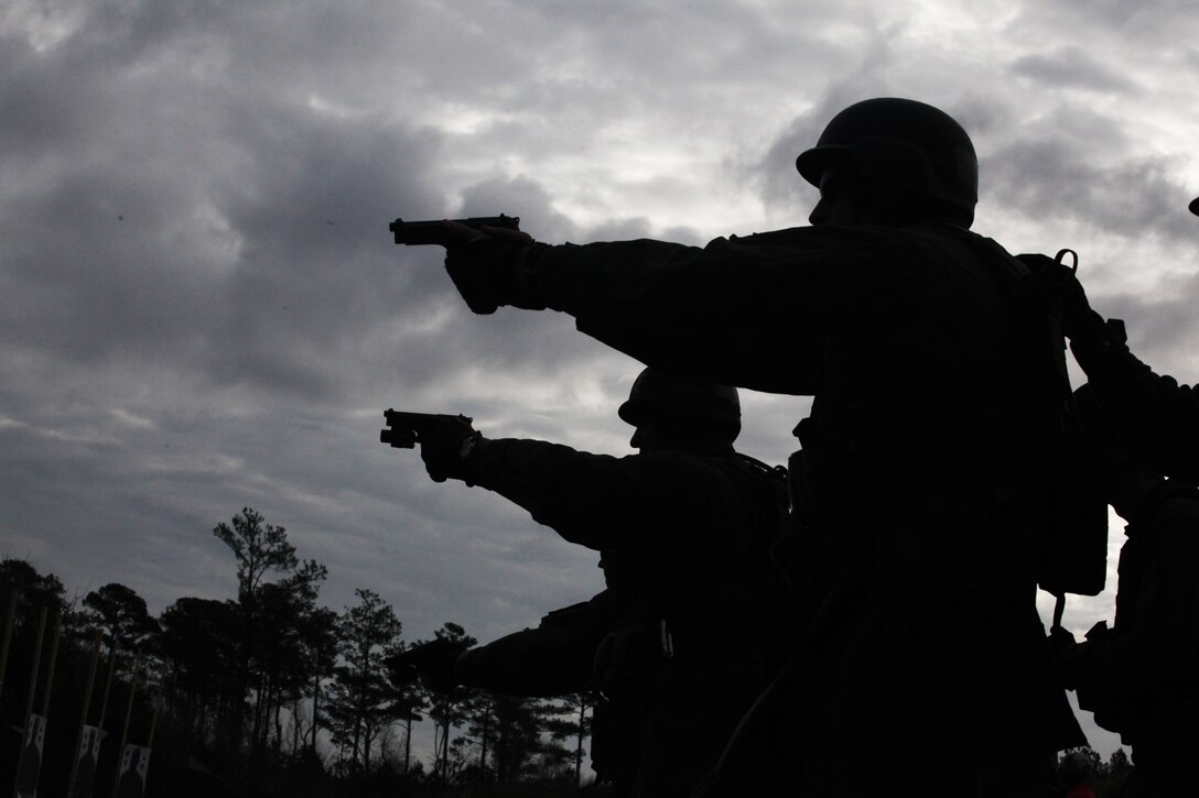 Students of the new Special Reaction Team course train to fire on the move with the aid of their fellow classmates at a Stone Bay range aboard Marine Corps Base Camp Lejeune, March 22. The new course will help Marine Corps installations fill their quota of SRT personnel, who provide a tactical edge to installation commanders looking to plan for and answer possible security and law enforcement threats.