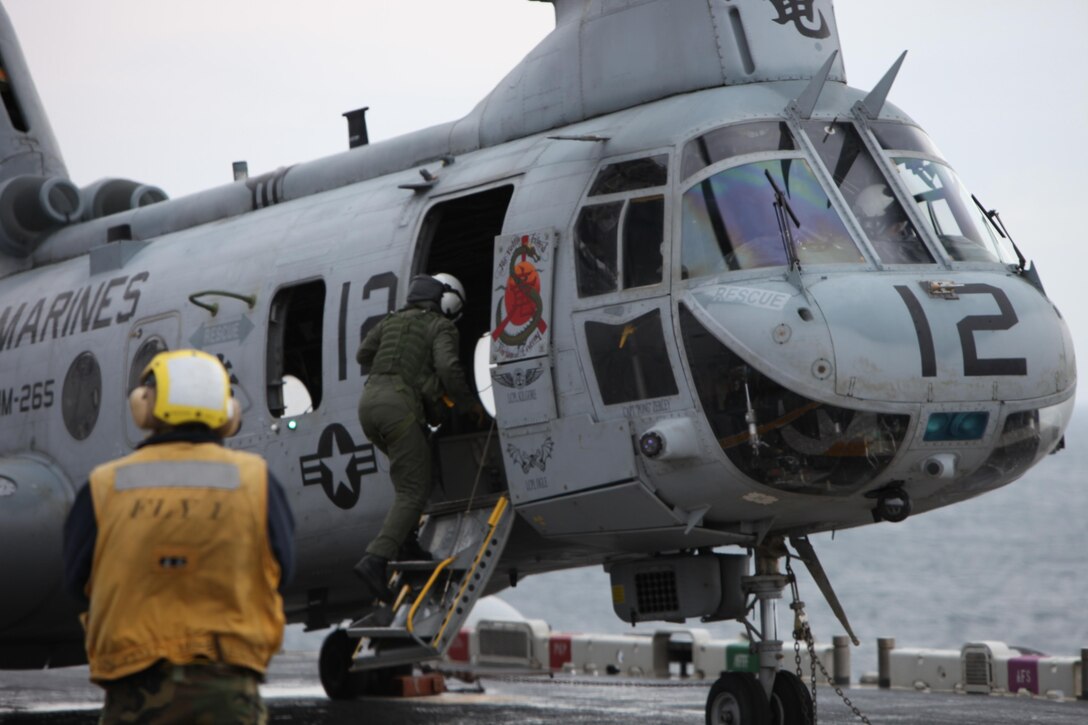 Captain Sarah Smith, CH-46E Sea Knight helicopter pilot with Marine Medium Helicopter Squadron 265 (Reinforced), 31st Marine Expeditionary Unit, climbs aboard her aircraft to begin the flight that surpassed the 12,000 flight hour milestone, March 22. The 31st MEU serves as the United States’ force in readiness for the Asia-Pacific region.