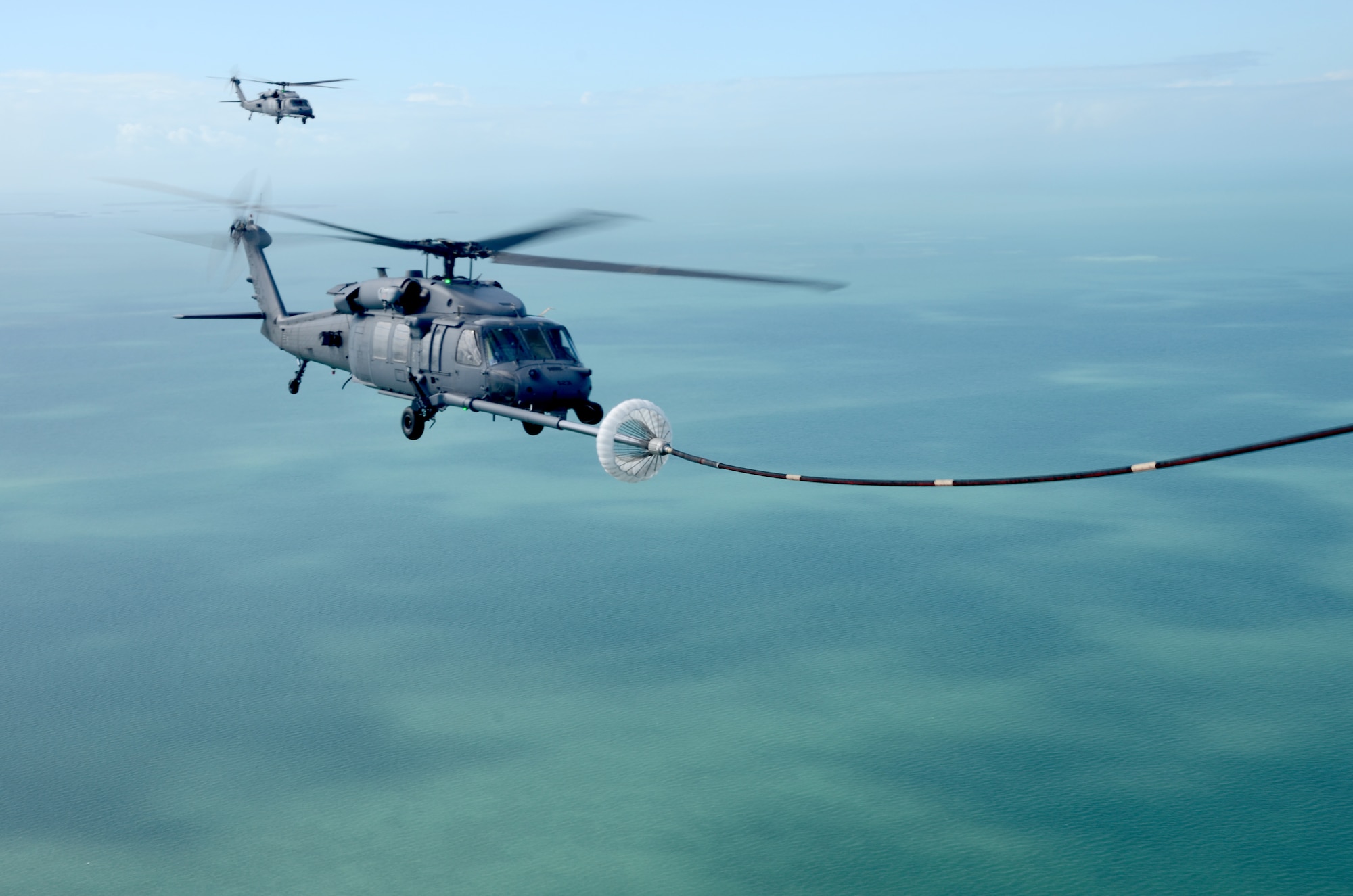 Search and rescue Aircrew Airmen from the 920th Rescue Wing, Patrick Air Force Base, Fla., pilot two HH-60G Pave Hawk helicopters near an HC-130P/N King aircraft to gas up from its extended hose and drogue. The U.S. Airmen participated in an international SAR exercise with Canadian SAR forces from Winnipeg's 17 Wing in Key West, Fla. this winter. (U.S. Air Force photo/Capt. Cathleen Snow)