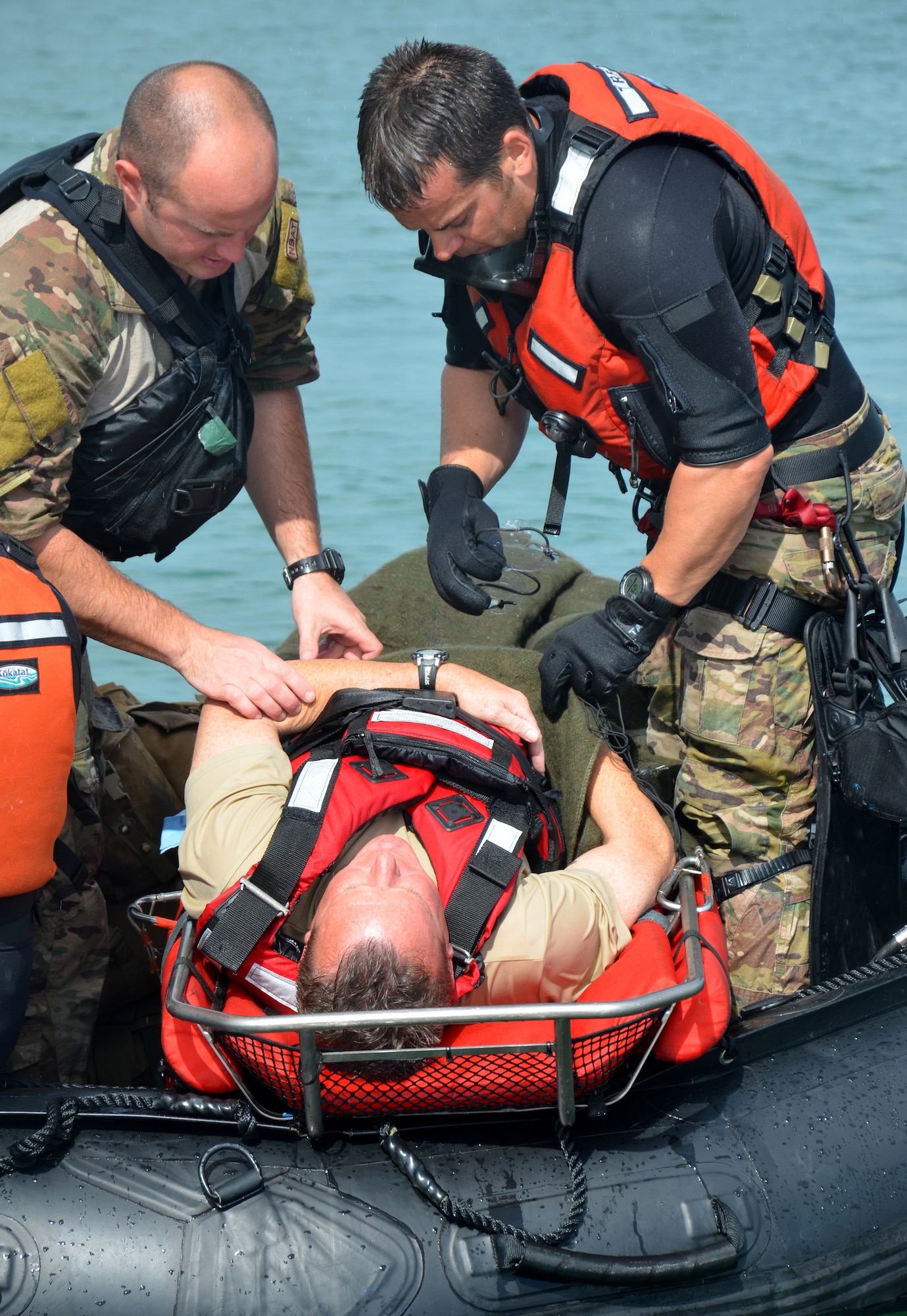 U.S. pararescue Airmen from the 920th Rescue Wing, Patrick Air Force Base, Fla., practiced basic medical procedures on a volunteer survior during the water rescue portion of an international joint search and rescue exercise with Canadian Airmen in Key West, Fla. this winter. The Airmen performed intravenous therapy on a rocking boat to fulfill one of the medical requirements. (U.S. Air Force photo/Senior Airman Natasha Dowridge)