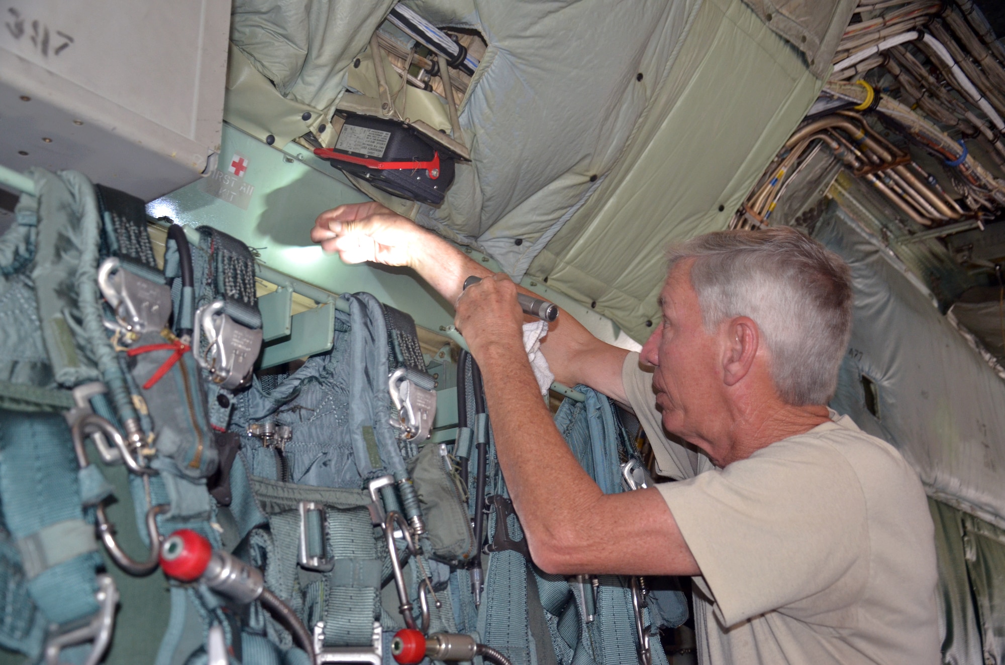 Tech. Sgt. Albert Crespo, C-130 aircraft crew chief, 920th Maintenance Squadron, Patrick Air Force Base, Fla., does maintenance checks on a C-130 aircraft during an international search and rescue exercise this winter in Key West, Fla.  Although he is doing pre-flight checks, U.S. and Canadian SAR maintenance Airmen participated in a competition similar to this actual job requirement called "lost tool." (U.S. Air Force photo/Senior Airman Natasha Dowridge)