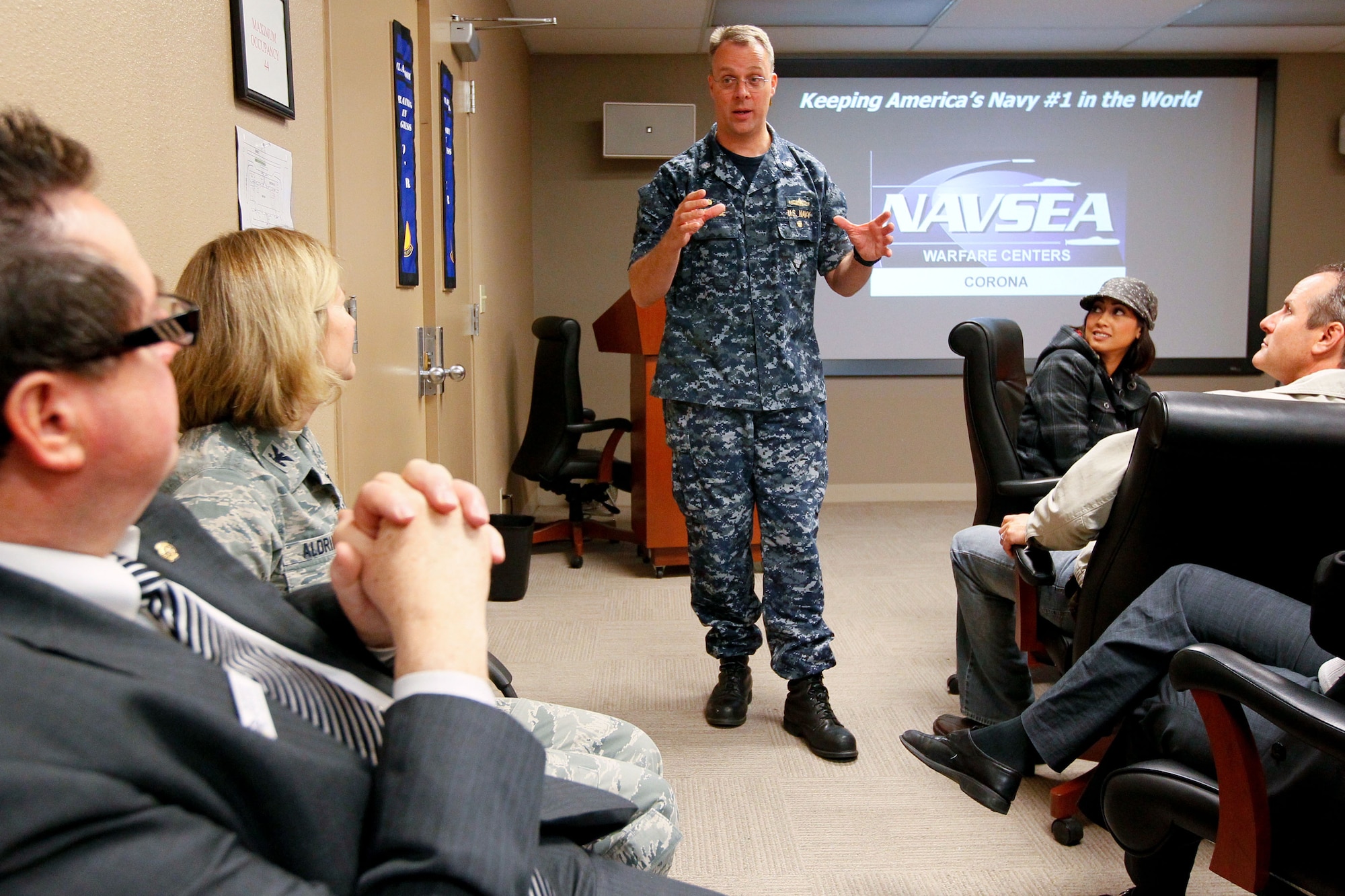Cmdr. Eric Ver Hage, commanding officer of Naval Surface Warfare Center, Corona Division, delivers remarks during the Greater Corona Valley Chamber of Commerce Executive Leadership Roundtable 2012 Military Day event on March 9th at the base. Ver Hage described Naval Surface Warfare Center Corona’s unique role as the Navy’s independent assessment agent, behind-the-scenes roles in numerous recent events and its economic impact on the region. The Leadership Corona class spent the day at the base learning about the various missions at March Field. (U.S. Navy photo by Greg Vojtko)