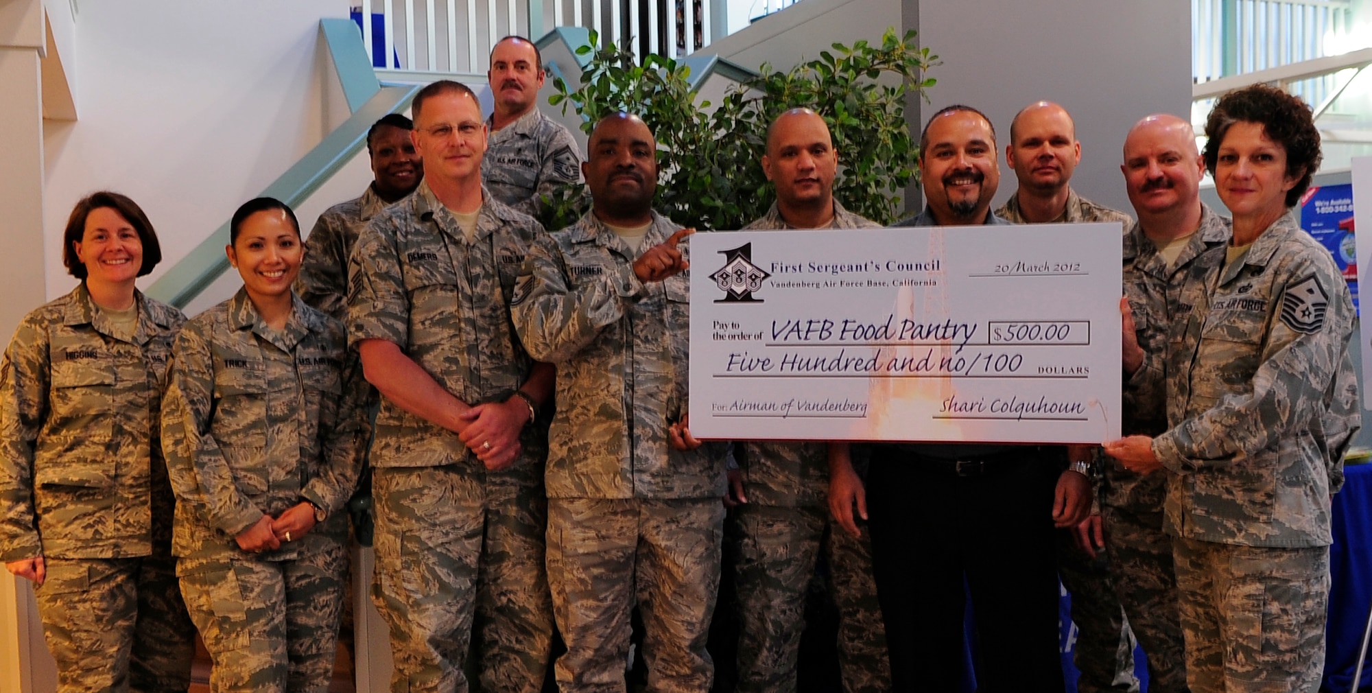 VANDENBERG AIR FORCE BASE, Calif. -- Members of the First Sergeant's Council present a $500 donation to the Vandenberg Food Pantry at the Airman & Family Readiness Center here Tuesday, March 21, 2012. The food pantry is a volunteer run program providing grocery items at no cost to Vandenberg families in need. (U.S. Air Force photo/Michael Peterson)