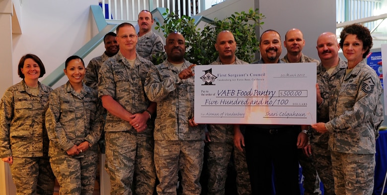 VANDENBERG AIR FORCE BASE, Calif. -- Members of the First Sergeant's Council present a $500 donation to the Vandenberg Food Pantry at the Airman & Family Readiness Center here Tuesday, March 21, 2012. The food pantry is a volunteer run program providing grocery items at no cost to Vandenberg families in need. (U.S. Air Force photo/Michael Peterson)
