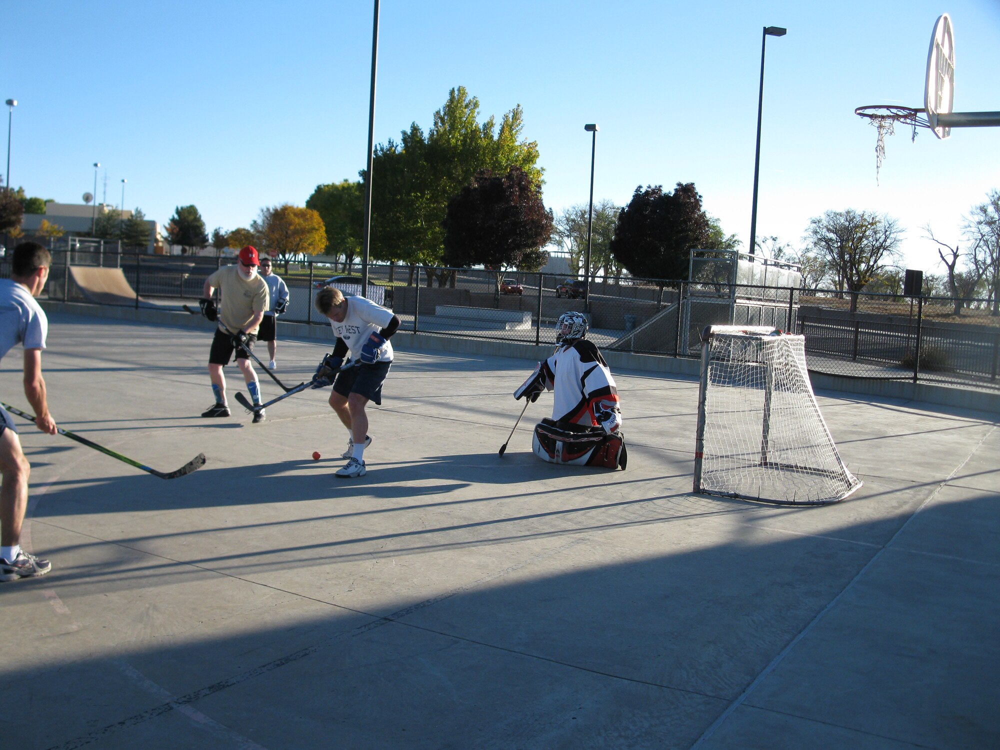 From left, Keith Forman, Andrew Pesantez, David Corby and Christian Davidson play street hockey at Kirtland Air Force Base.
