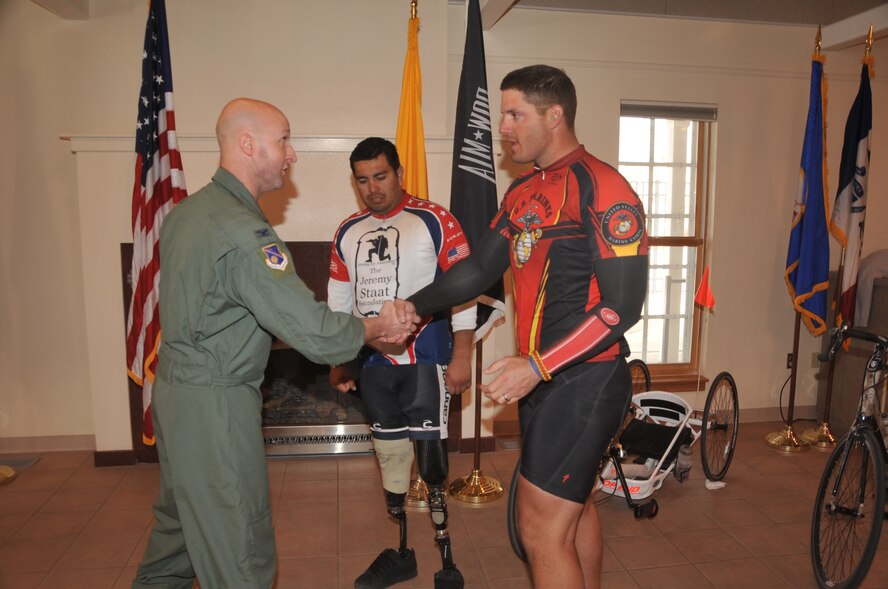 Col. Daniel Pepper, 377th Air Base Wing chief of current operations, presents a Team Kirtland coin March 18 to Jeremy Staat while Wesley Leon-Barrientos looks on.

Photo by Todd Berenger
