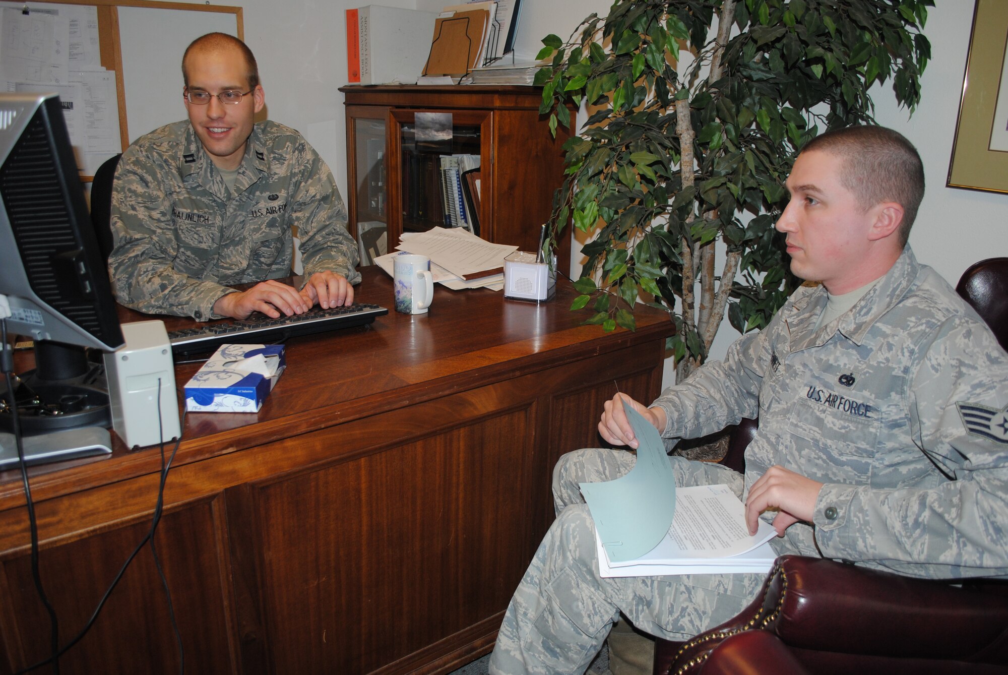 Capt. Stephen Braunich, 341st Missile Wing chief of legal assistance and preventative law, assists Staff Sgt. Wayne Bennett, 341st Maintenance Operations Squadron assistant NCO in charge of the Aerospace Ground Equipment shop, with a durable power of attorney. The base legal office provides various services to the members of Team Malmstrom on a daily basis. (U.S. Air Force photo/Airman 1st Class Katrina Heikkinen)