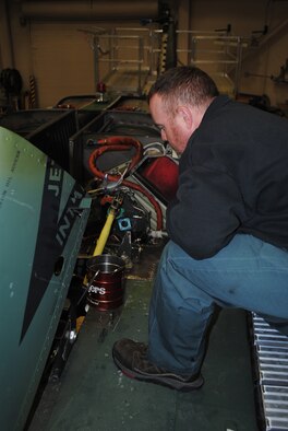Robert Huston, 341st Maintenance Operations Squadron aircraft worker, works on bleeding the rotor break system of a UH-1N Helicopter during a phase inspection. (U.S. Air Force photo/Airman 1st Class Katrina Heikkinen)