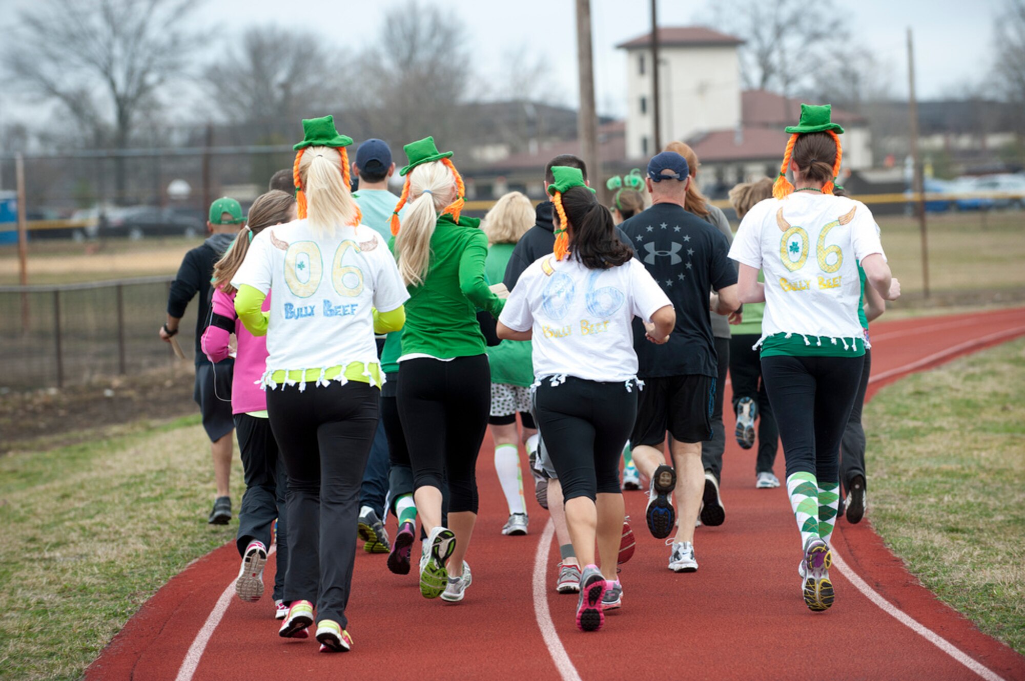 Runners from this year St. Patty's Day Pot O' Gold 5K run on the track adjacent to Pudgy's Sports Bar and Grill March 16 here. (U.S. Air Force photo by Russ Meseroll/Released)