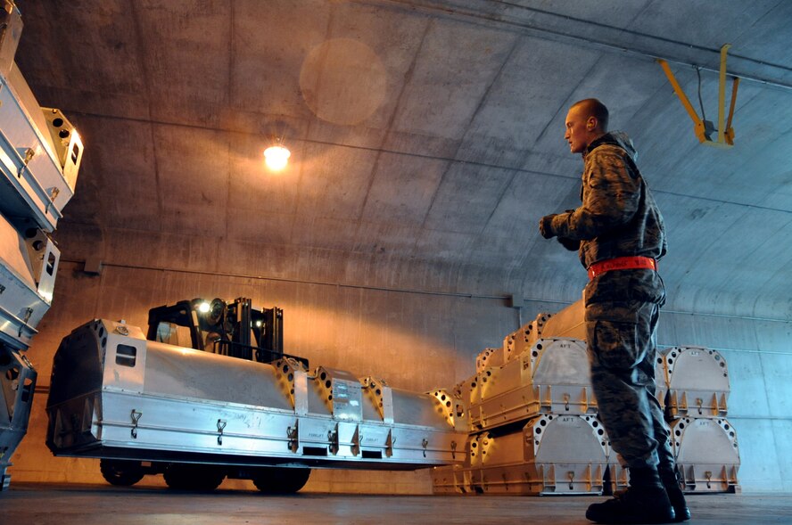 Airman 1st Class Evan Kirchner, 2nd Munitions Squadron, directs a forklift in the munitions storage area on Barksdale Air Force Base, La., March 21. Airmen from the 2 MUNS rearranged munitions in the storage area to make more space for an incoming shipment of Miniature Air Launch Decoys. (U.S. Air Force photo/Airman 1st Class Micaiah Anthony)(RELEASED) 