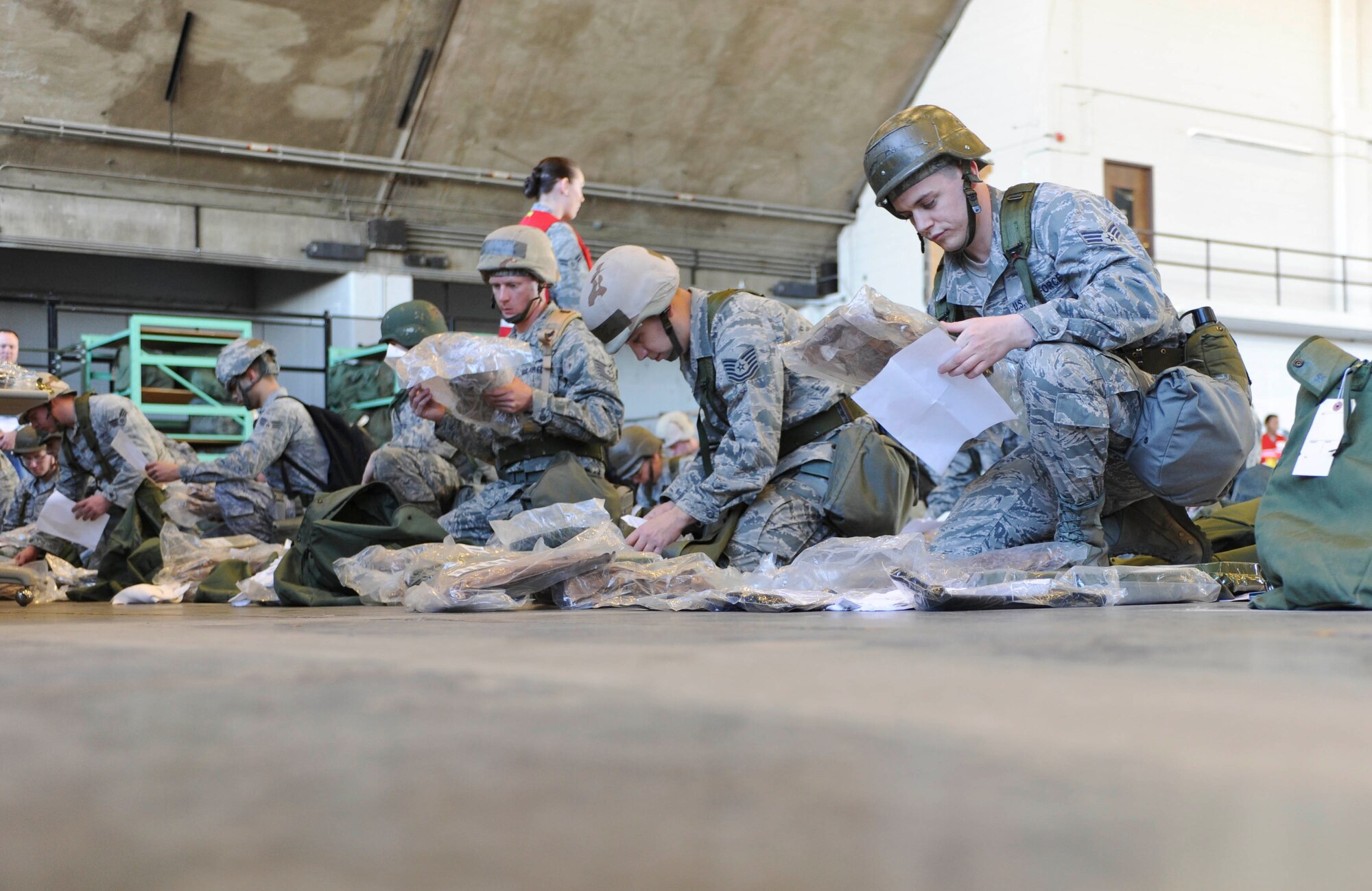 Airmen verify items on their checklists prior to processing through the Personnel Deployment Function line during a Phase I Operational Readiness Exercise at Ellsworth Air Force Base, S.D., March 14, 2012.  Each Airman’s bags were inspected for necessary and required items.  (U.S. Air Force photo by Airman 1st Class Anania Tekurio/Released)