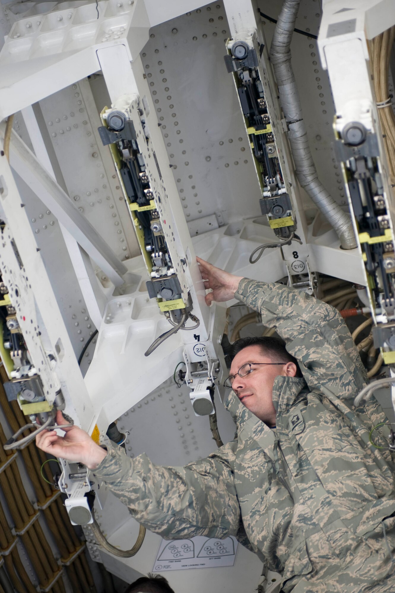 Master Sgt. Robert Cortez, 34th Aircraft Maintenance Unit assistant flight chief, performs an inspection of a B-1 bomber bomb bay during the Phase I Operational Readiness Exercise at Ellsworth Air Force Base, S.D., March 14, 2012.  The pre-flight inspection ensures the aircraft is combat ready.  (U.S. Air Force photo by Airman 1st Class Anania Tekurio/Released) 