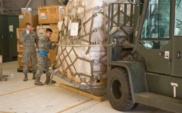Airman 1st Class Kristopher Esparza, 28th Logistics Readiness Squadron, secures cargo during the Phase I Operational Readiness Exercise at Ellsworth Air Force Base, S.D., March 14, 2012.  Pallets of B-1B parts were transported to a processing line where inspectors checked and weighed them for proper storage or transportation.  (U.S. Air Force photo by Airman 1st Class Anania Tekurio/Released) 