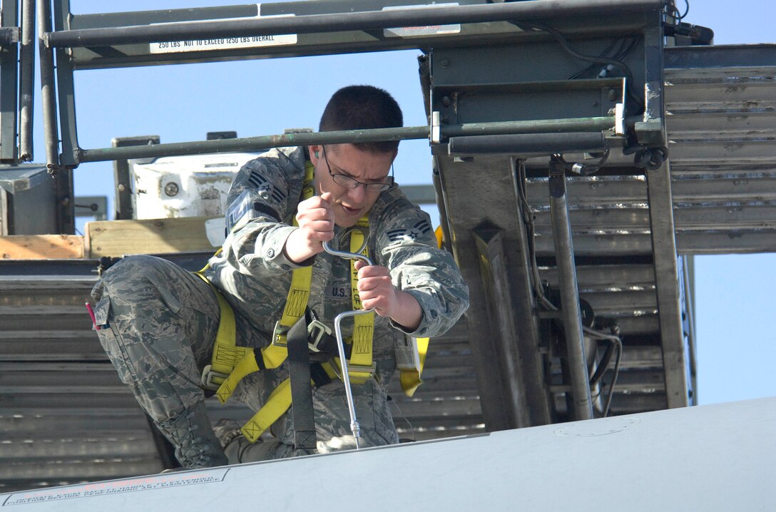 Senior Airman Jason Ellis, 28th Aircraft Maintenance Squadron weapons load team member, installs flares into a B-1 bomber during the Operational Readiness Exercise at Ellsworth Air Force Base, S.D., March 16, 2012.  The ORE, which ran from March  14 to 16, tested the ability of Airmen to prepare and respond to a real world tasking.  (U.S. Air Force photo by Airman 1st Class Anania Tekurio/Released).