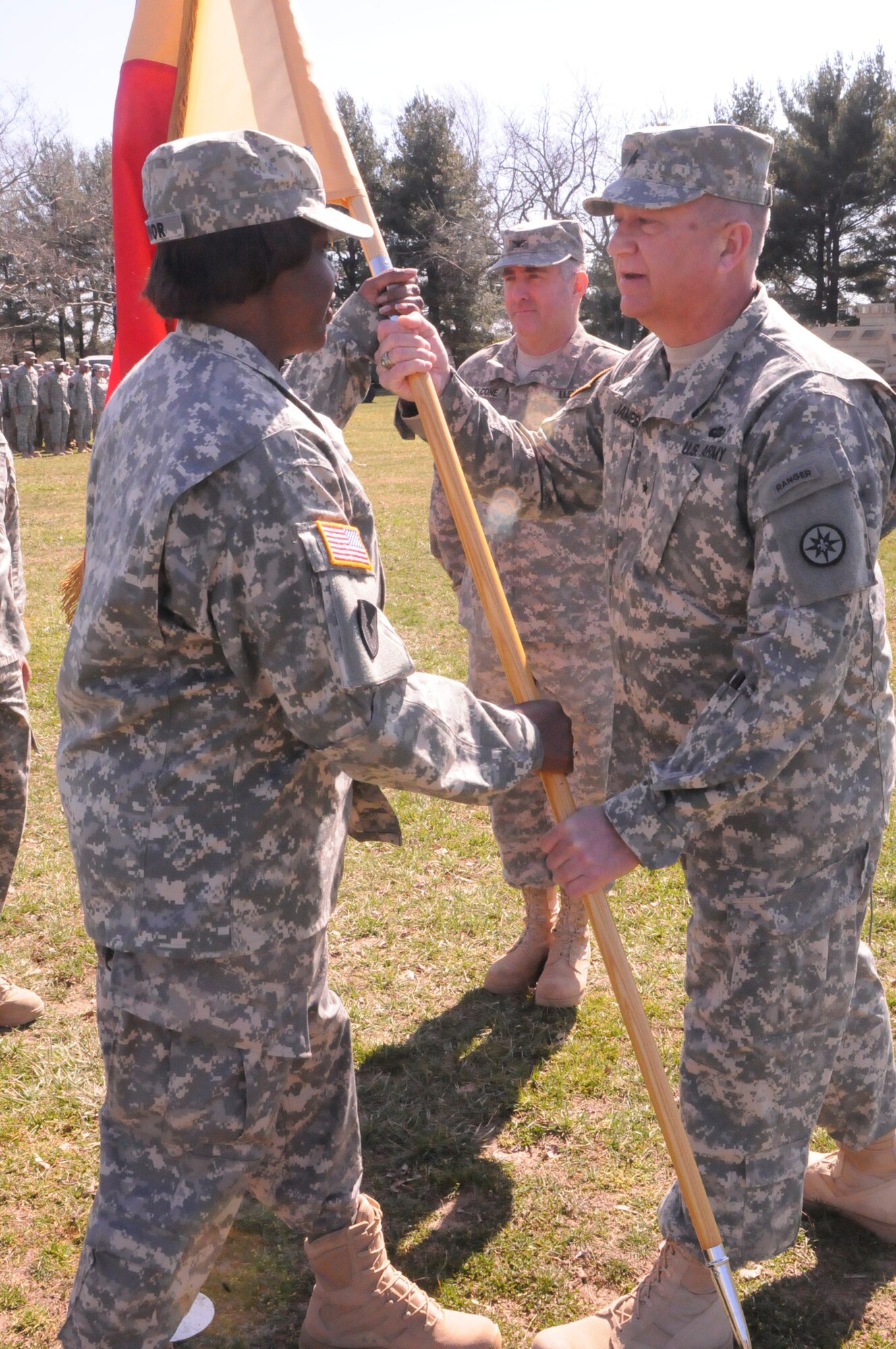 Col. Joyce Junior, (left) assumed command of the 77th Sustainment Brigade from Brig. Gen. Bud R. Jameson, Jr. (right) as outgoing commander, Col. Stephen Falcone (center) looks on, during a change of command ceremony March 12 here. Jameson addressed the crowd filled Soldiers mission partners, and civilians regarding the significance of the day’s events and credited Falcone and the 77th Sustainment Brigade Soldiers with maintaining the unit’s World War I and World War II legacy. (U.S. Army courtesy photo/Released) 