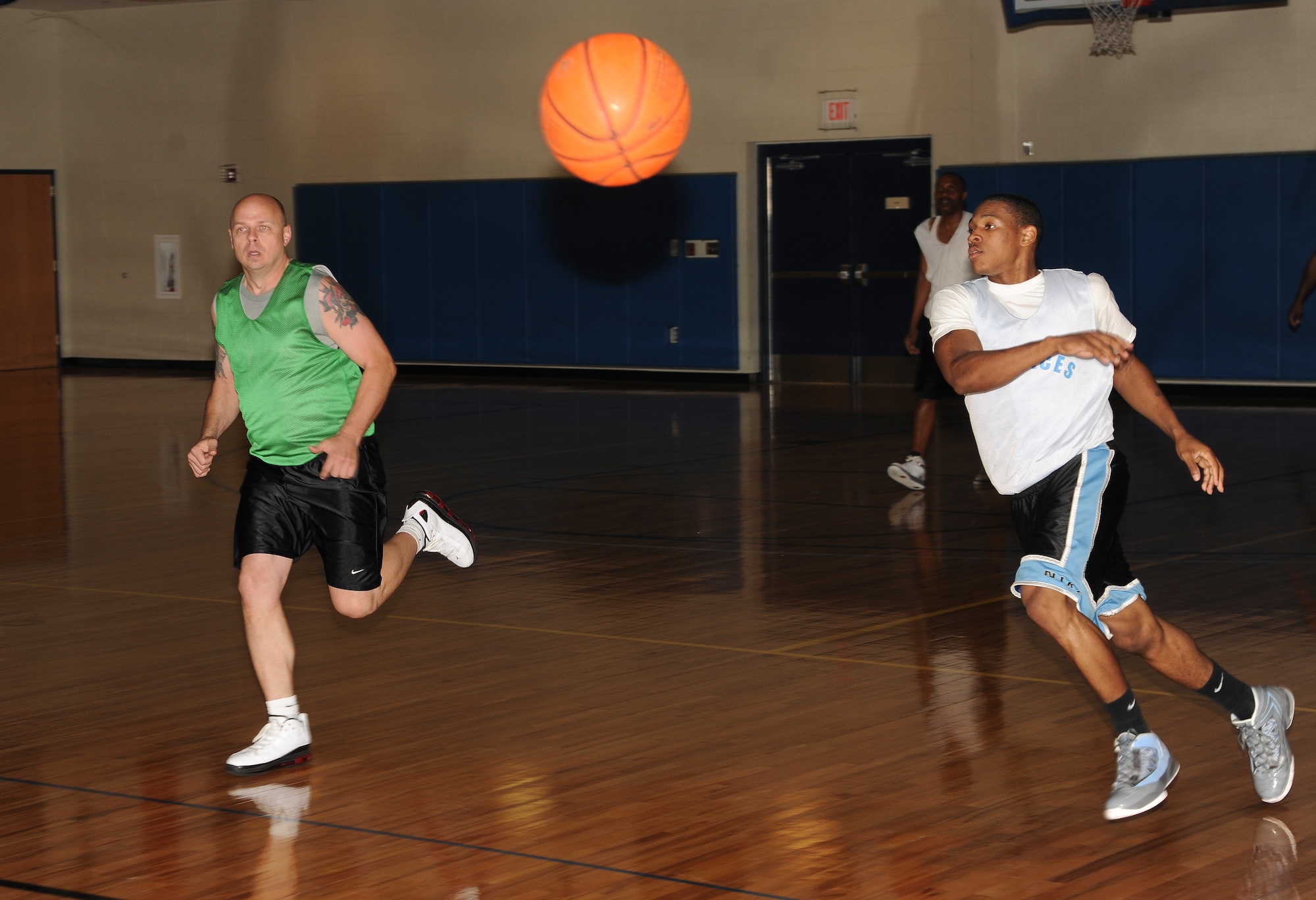 Arrington Perry, 23d Force Support Squadron spreads the floor with a no-look pass to his teammate during the intramural basketball championship game Moody Air Force Base Ga., March 21, 2012. The 23d FSS started the game strong and led the 23d Maintenance Operations Squadron 19 to 7 only five minutes into the game.  (U.S. Air Force photo by Airman 1st Class Paul Francis/Released)
