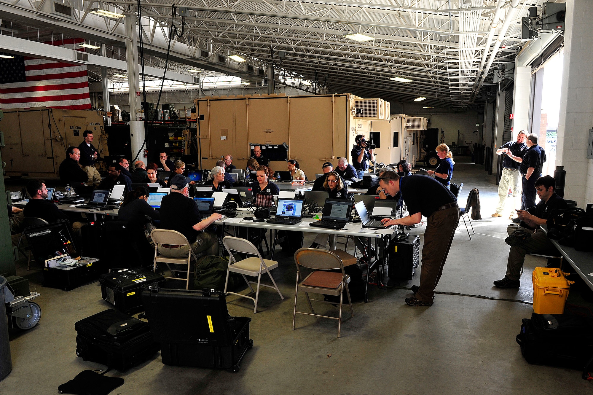 Members of the Federal Emergency Management Agency operate a temporary emergency operations center during an operational readiness exercise hosted by the 621st Contingency Response Wing at the Global Reach Deployment Center March 20 here. Airmen from the CRW were tasked to provide cargo preparation and joint inspection expertise and a sheltered working area for FEMA to set up a mobile command center and test its equipment. (U.S. Air Force photo by Tech. Sgt. Parker Gyokeres/Released)