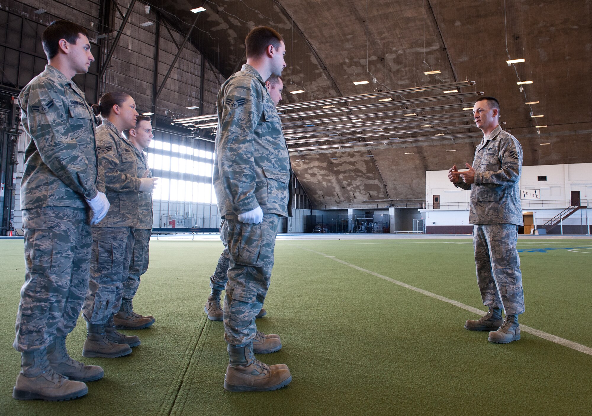 Tech. Sgt. Michael Lewis, NCO in charge of the Ellsworth Honor Guard, instructs honor guard members during a funeral practice sequence in the Pride Hangar at Ellsworth Air Force Base, S.D., March 19, 2012. The base honor guard is responsible for providing military honors throughout a 114,636 square mile area covering South Dakota, western Nebraska and northern Wyoming.  (U.S. Air Force photo by Airman 1st Class Kate Thornton/Released)