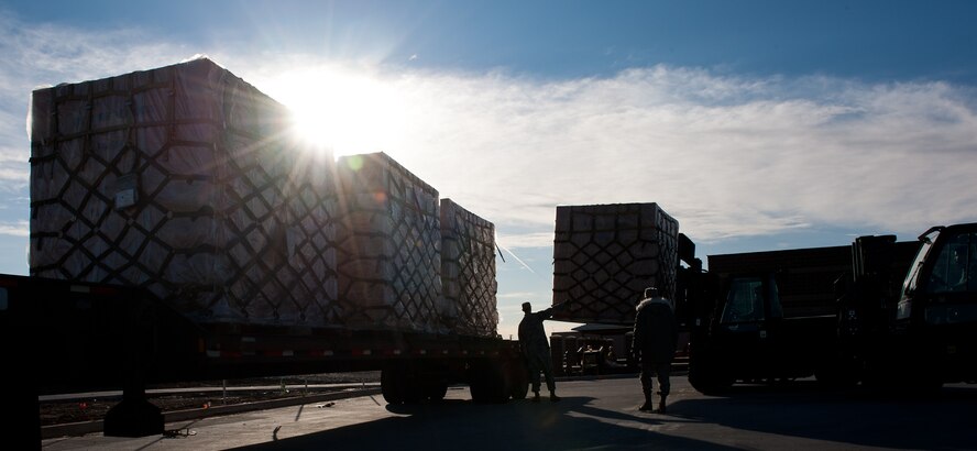 Airmen of the 28th Logistics Readiness Squadron vehicle operations section unload pallets of cargo at the new deployment processing center on Ellsworth Air Force Base, S.D., March 21, 2012. The new deployment center will be a well-equipped facility used to prepare and process personnel and cargo during exercises and contingencies. (U.S. Air Force photo by Airman 1st Class Kate Thornton/Released)