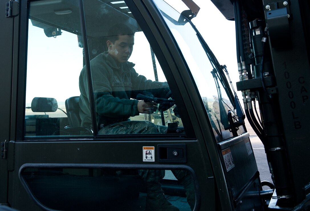 Airman 1st Class Matthew Sinnemaki, 28th Logistics Readiness Squadron vehicle operations apprentice, operates a forklift to move cargo destined for the new deployment processing center on Ellsworth Air Force Base, S.D., March 21, 2012. The upgraded deployment center will be used to prepare and process personnel and cargo during exercises and contingencies. (U.S. Air Force photo by Airman 1st Class Kate Thornton/Released)