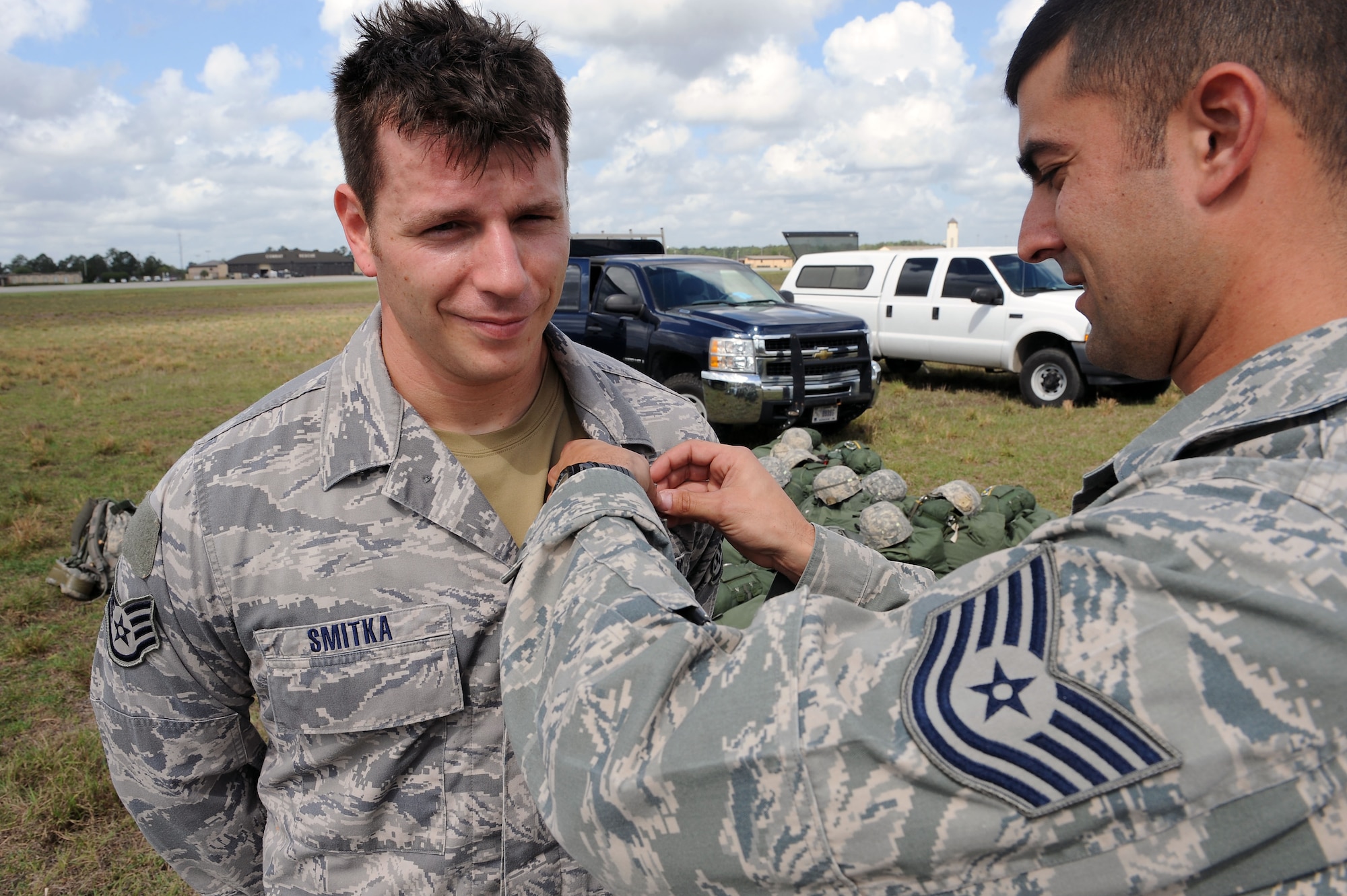 U.S. Air Force Staff Sgt. Tyler Smitka, 823d Base Defense Squadron fire team leader, receives a senior rated jumpmaster badge from Tech. Sgt. David Edwards, 820th Combat Operations Squadron, at Moody Air Force Base Ga., March 21, 2012. Smitka earned the badge after completing 32 jumps and all requirements for senior rated jumpmaster. (U.S. Air Force photo by Staff Sgt. Ciara Wymbs/Released)  