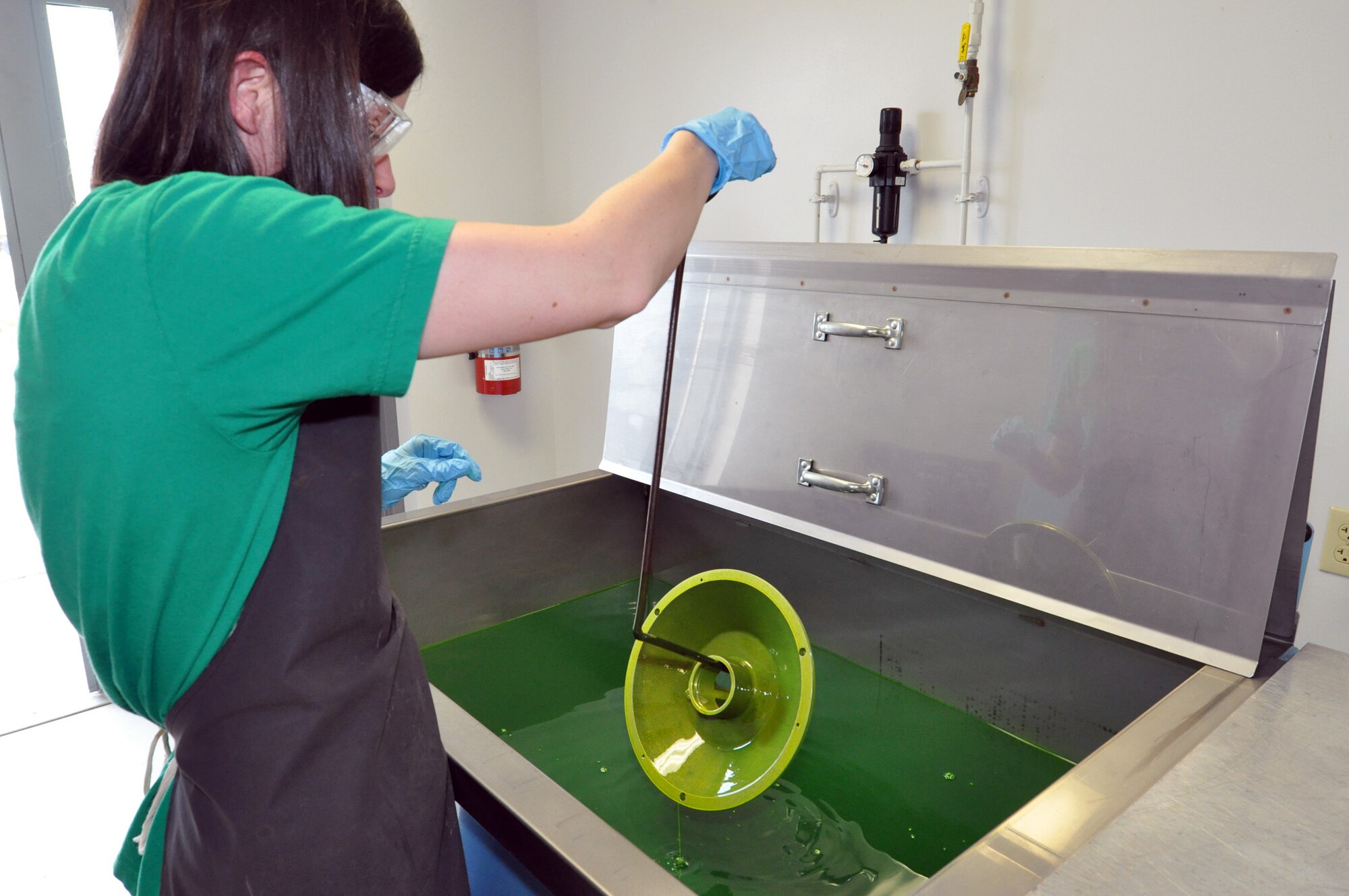 Kathy Morrison, 442nd Maintenance Squadron Nondestructive Inspection technician, dips a component from an A-10 Thunderbolt II into a chemical bath in order to detect cracks  March 19, 2012. The 442nd MXS NDI shop is responsible for testing aircraft components for defects. The shop is part of the 442nd Fighter Wing, an A-10 Thunderbolt II Air Force Reserve unit at Whiteman AFB, Mo. (U.S. Air Force photo/Senior Airman Wesley Wright)
