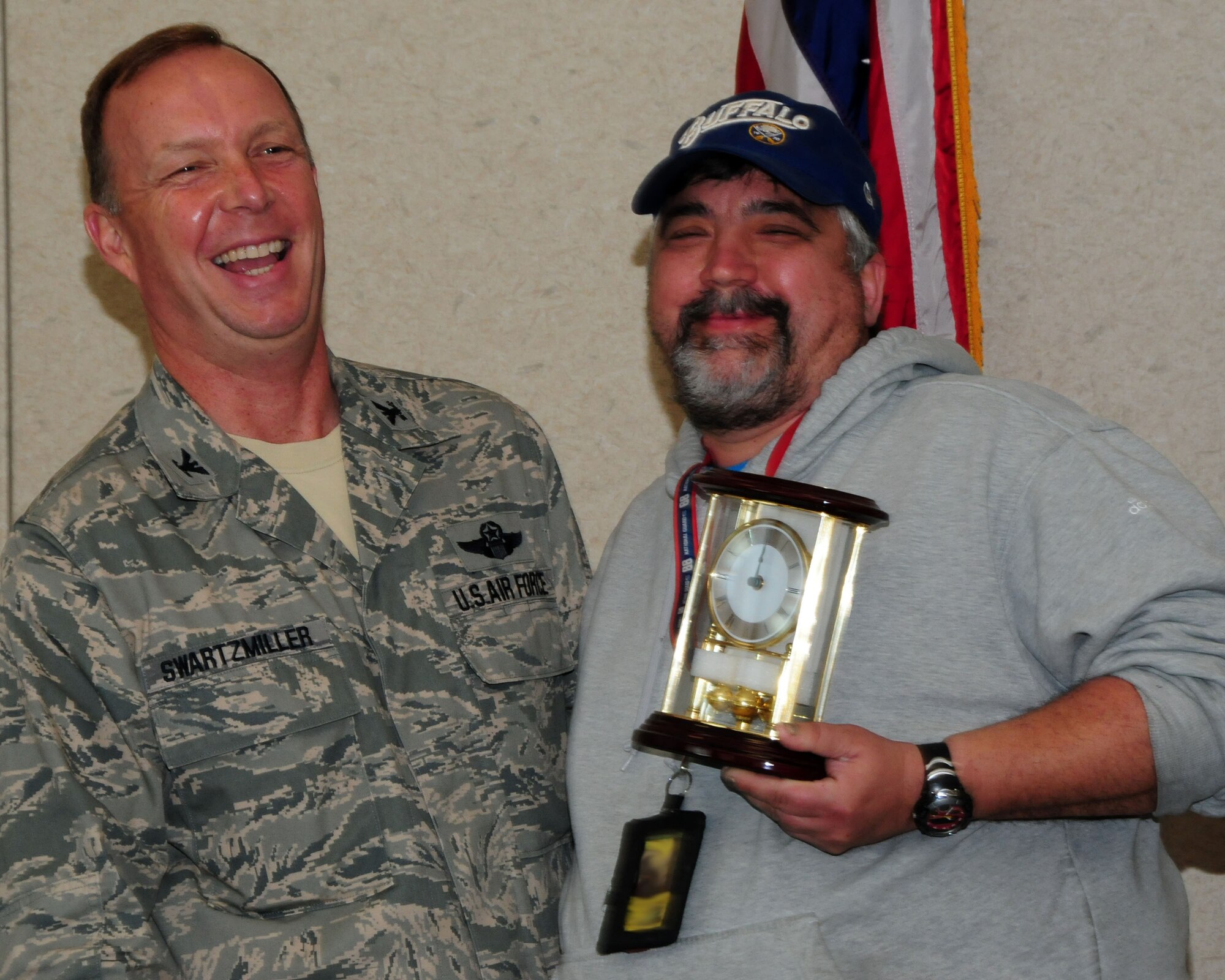 Mr. Dennis Paradowski, 914th Maintenance Group aerospace propulsion specialist, adds a bit of comic relief with Col. Allan Swartzmiller, 914th Airlift Wing commander, while receiving the annual 914th Airlift Wing Civilian Award on March 21, 2012 at the Niagara Falls Air Reserve Station, NY.  Paradowski was one of several recipients who received an award during a civilian commander's call here. (U.S. Air Force illustration by Peter Borys)