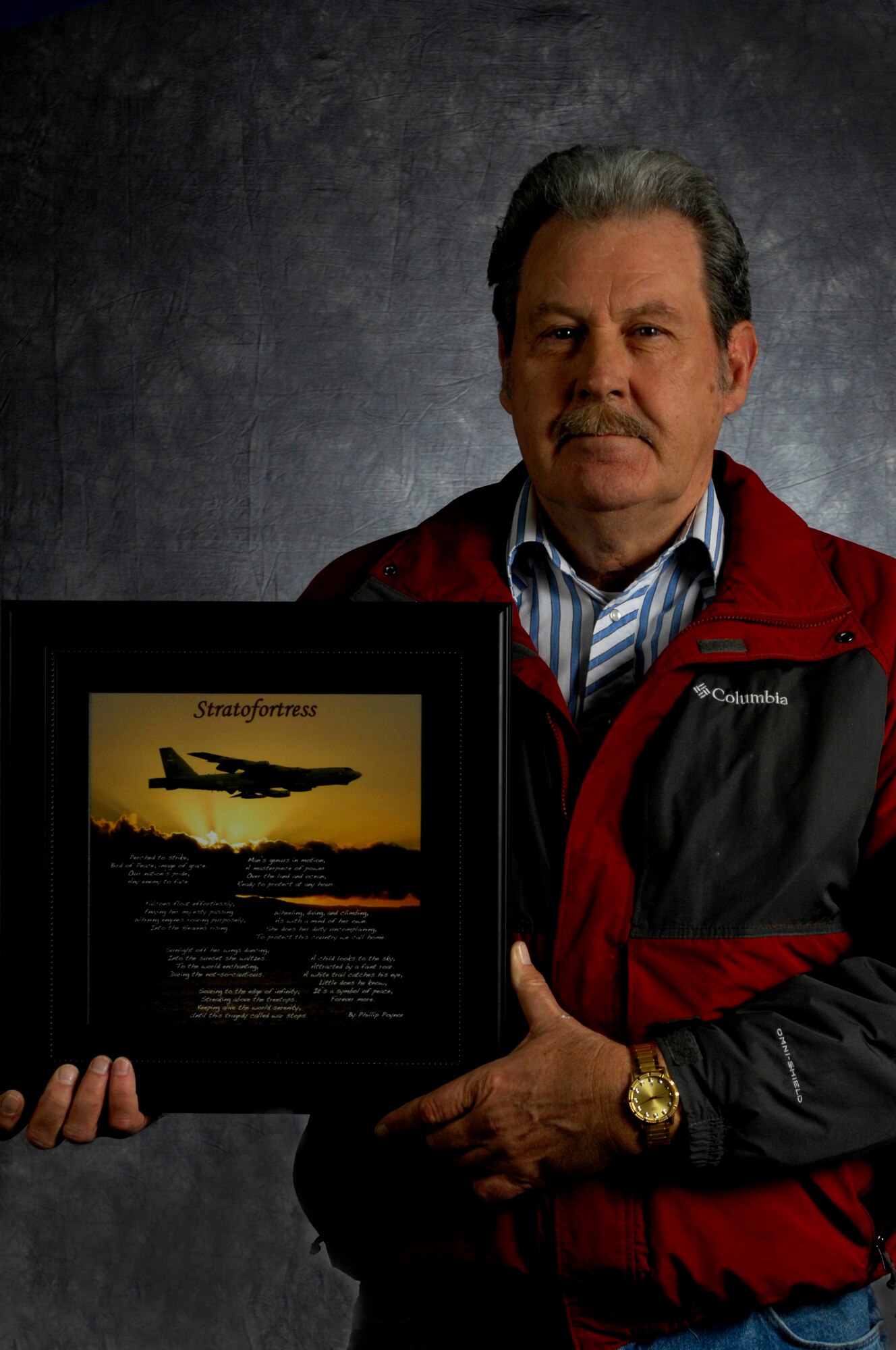 MINOT AIR FORCE BASE, N.D. -- Phillip Poynor, a retired Air Force defense fi re control system technician, wrote a poem inspired by the B-52H Stratofortress in 1973. The poem was laid on top of a picture of the B-52 and was given as a gift from Poynor’s son, Tech. Sgt. Jason Poynor, and his fi ancée, Gina. The picture was on display in the 5th Bomb Wing Headquarters building for a week in March. (U.S. Air Force photo/Senior Airman Jesse Lopez)