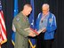 Brigadier Gen. John McMullen, 325th Fighter Wing commander awarded World War II veteran, Taffe S. Simon, with a medallion during his visit at Tyndall, almost 70 years since he went to gunnery school here. (U.S. Air Force photo by Chris Cokeing)