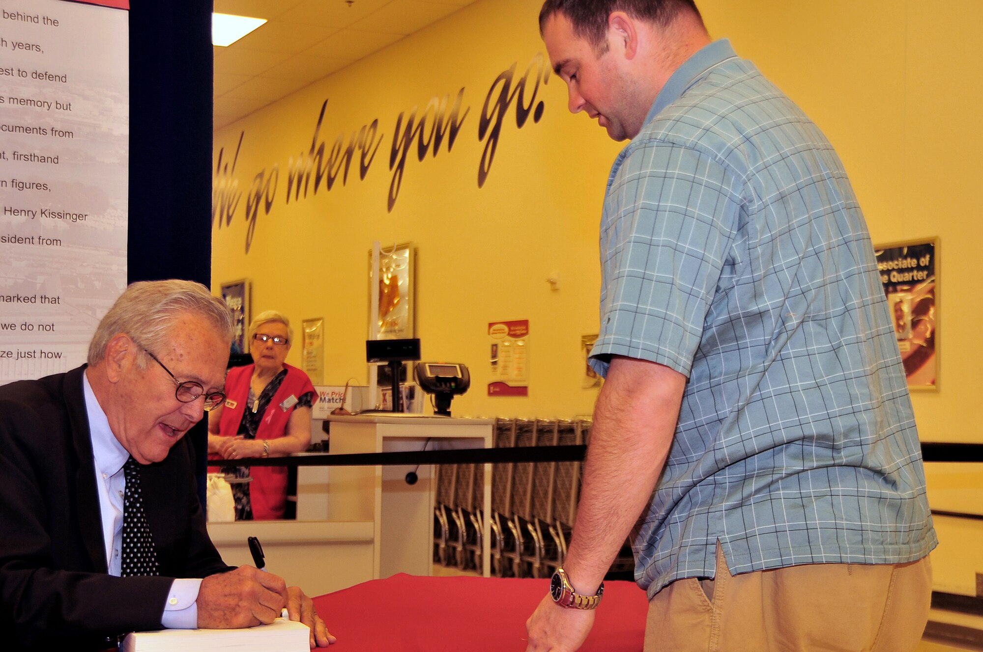 OFFUTT AIR FORCE BASE, Neb - Former Secretary of Defense Donald Rumsfeld signed a copy of his book titled "Known and Unknown: A Memoir" for Chris Shive, a civilian contractor at Offutt, March 18.  Rumsfeld is giving all of his profits from the book's sale to veterans' charities. (Air Force photo by D.P. Heard/Released)