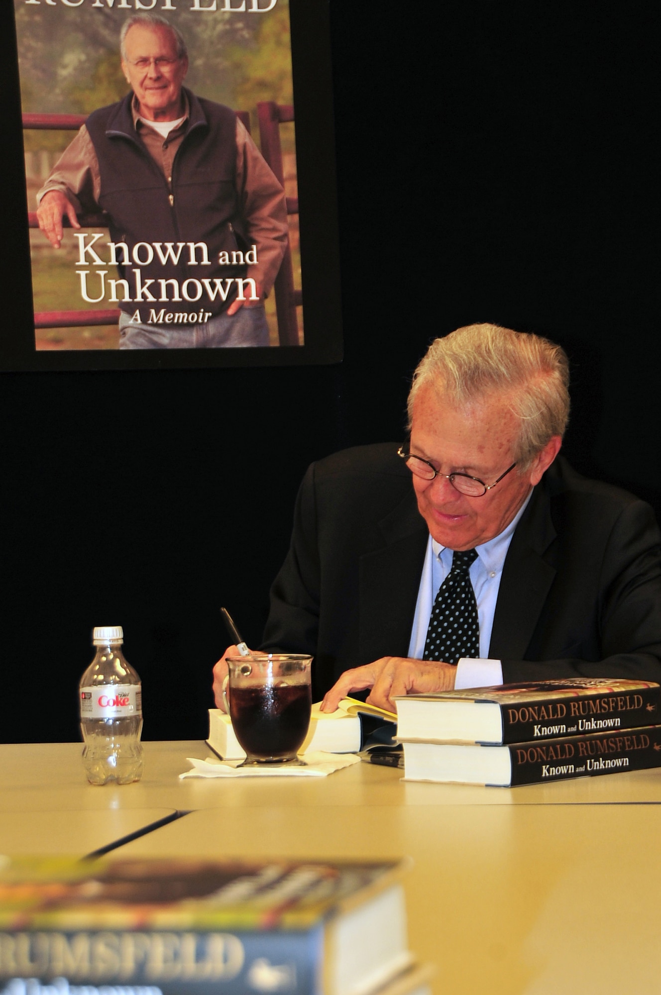 OFFUTT AIR FORCE BASE, Neb - Former Secretary of Defense Donald Rumsfeld signs a copy of his book titled "Known and Unknown: A Memoir"   at the Offutt Air Force Base Exchange March 18. Rumsfeld is giving all of his profits from the book's sale to veterans' charities. (Air Force photo by D.P. Heard/Released)