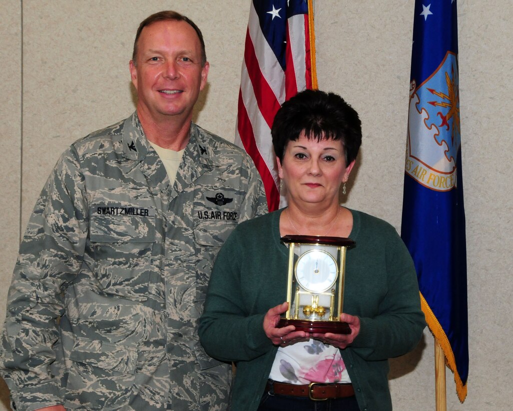 Mrs. Donna Jellison, 914th Force Support Squadron administrative assistant, poses for a photo with Col. Allan Swartzmiller, 914th Airlift Wing commander after receiving the annual 914th Airlift Wing Civilian Award on March 21, 2012 at the Niagara Falls Air Reserve Station, NY.  Jellison was one of several recipients who received an award during a civilian commander's call here. (U.S. Air Force photo by Peter Borys)